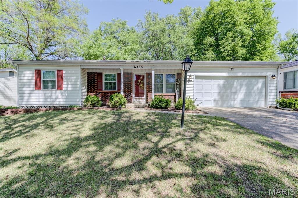 Wonderful opportunity to own this charming 3-bedroom, 2.5-bath ranch with a 2-car garage, set on a welcoming level fenced lot with mature trees. The low-maintenance exterior features vinyl siding, a brick front, enclosed soffits, wrapped fascia, gutter covers, thermal windows, an updated garage door with coach lights, decorative stone accents and attractive landscaping. Relax on the cozy covered front porch before stepping into the formal living room. The inviting dining room opens to the kitchen, showcasing gleaming wood floors and a sliding door leading to the patio and backyard. The eat-in kitchen offers abundant wood cabinetry, stainless steel appliances, a built-in storage peninsula and a pleasant yard view. The primary suite includes a convenient adjoining renovated half bath. Plus, two additional bedrooms. Enjoy updated ceiling fans, light fixtures, blinds, new carpet 2 bedrooms, garbage disposal and hot water heater. The finished lower level is perfect for entertaining or relaxing, featuring a large recreation room, den with cedar closet, full bath and exceptional storage with built-in shelving. Refrigerator, washer and dryer included. NEW architectural roof to be installed prior to closing!