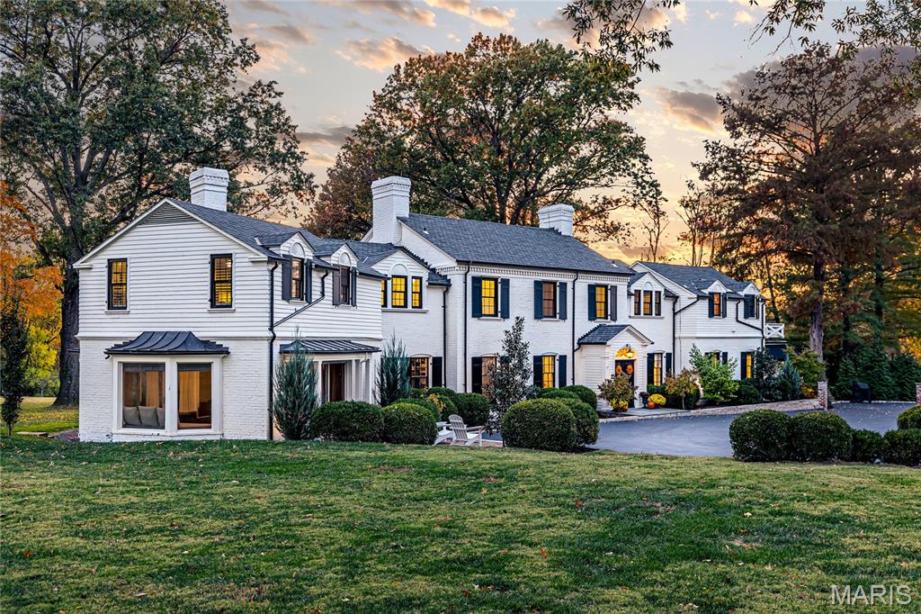 Welcome to 10426 White Bridge Lane, a truly distinguished estate set on just over two private acres in the heart of Creve Coeur, where timeless 1934 architecture has been masterfully reimagined for modern luxury living. Offering more than 5,400 square feet above grade, this five-bedroom, five-bath residence is rich in character, showcasing historic millwork, crown molding, custom built-ins, tray ceilings, and four wood-burning fireplaces that create warmth and elegance throughout. From the gracious entrance foyer to the expansive formal living and dining rooms, every space is thoughtfully designed for both elevated entertaining and refined everyday living. The chef’s kitchen is a statement in both beauty and function, featuring custom cabinetry, a generous center island, high-end stainless appliances including built-in refrigeration, and seamless connection to inviting gathering spaces and breakfast areas filled with natural light. A library, bar area, and beautifully appointed rooms throughout the main level provide flexibility for hosting, working, or relaxing in style. The fully finished walk-out lower level expands the living experience with a spacious recreation area, wet bar, full bath, fitness space, and abundant storage ideal for entertaining or private retreat. Upstairs, five well-appointed bedrooms include a luxurious primary suite complete with fireplace and spa-inspired bathroom, offering a peaceful sanctuary overlooking the manicured grounds. Each additional bedroom is generously sized with updated finishes and thoughtful details. Outdoors, the estate transforms into a private oasis with mature landscaping, open green space, and a stunning in-ground pool designed for summer gatherings and quiet evenings alike. The circular driveway and three-car garage add both convenience and impressive curb appeal, while the expansive lot offers a rare blend of privacy and prestige. This exceptional property embodies historic sophistication, modern comfort, and elevated living in one of St. Louis’ most coveted settings.