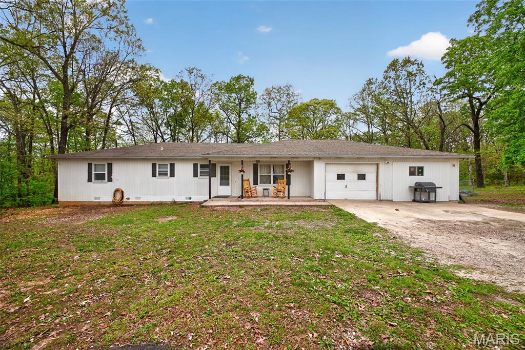 Enjoy the peace and privacy of country living with this charming home set on over 7 acres just outside of town. Offering 3 bedrooms, 2 bathrooms, and 1,588 square feet of comfortable living space, this property provides the perfect balance of functionality and room to grow. The home features a welcoming layout with ample natural light and a cozy feel throughout. Step outside to take in the wide-open space, ideal for relaxing, entertaining, or creating your own hobby farm. A spacious shop adds incredible value, perfect for storage, projects, or a home-based business. Tucked away in a quiet, private setting, this property offers the tranquility you’ve been looking for while still being a short drive to town amenities.