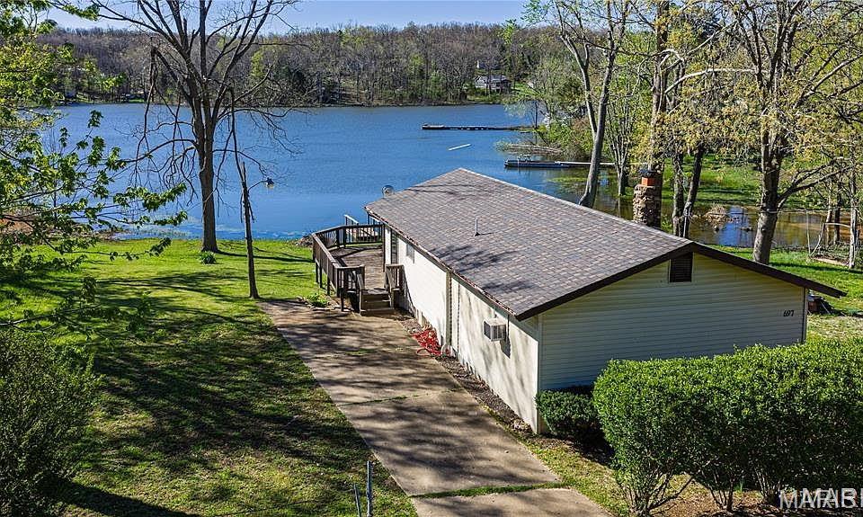 Escape to peace and tranquility with this charming lakefront cabin! Whether you're looking for the perfect weekend retreat or a place to call home year-round, this cozy 2-bedroom, 1-bath getaway offers the ideal blend of comfort and relaxation. The open-concept kitchen, dining, and living area creates a warm, inviting space for gathering with family and friends. Step outside onto the spacious deck overlooking the lake and enjoy your morning coffee, evening sunsets, or simply take in the serene waterfront views. A 10x14 utility shed provides plenty of storage for lake toys, lawn equipment, or patio furniture during the winter months. Don't miss this opportunity to own your own slice of lakefront paradise!  Seller is offering a Home Warranty up to $700.