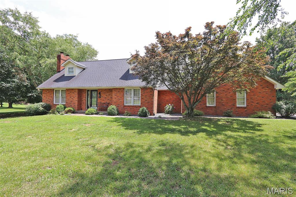 Nestled on a gorgeous 1-acre lot, this beautifully maintained 3-bedroom, 4-bath home offers the perfect blend of space, comfort, and classic charm. From the moment you arrive, you’ll appreciate the curb appeal of this all-brick home surrounded by mature trees and meticulously landscaped grounds. Inside, you’ll find hardwood floors throughout and a thoughtfully designed floor plan. The spacious main-level primary suite provides a private retreat complete with an en-suite bath, while the convenient main-floor laundry room and half bath add everyday functionality.
The inviting living room features a cozy gas fireplace, creating the perfect gathering space for family and friends. Upstairs, you’ll discover two additional bedrooms and a full bath, offering plenty of room for family or guests. The lower level features a 4th bath and a stunning wood-burning fireplace, making it an ideal spot for creating the ultimate recreation room and family room. 
Step outside onto the expansive deck overlooking the beautifully landscaped backyard, where you’ll enjoy peaceful mornings, summer barbecues, and breathtaking views of your private outdoor oasis.
Car enthusiasts and hobbyists will love the oversized 2-car attached garage, plus the additional John Deere room/third garage in the basement, providing exceptional storage and workspace options. If you’ve been searching for a home that combines quality construction, generous living space, and an unbeatable setting in the highly sought-after Jackson R-2 School District, this is one you won’t want to miss! Classic elegance, exceptional space, and a setting you’ll love coming home to.