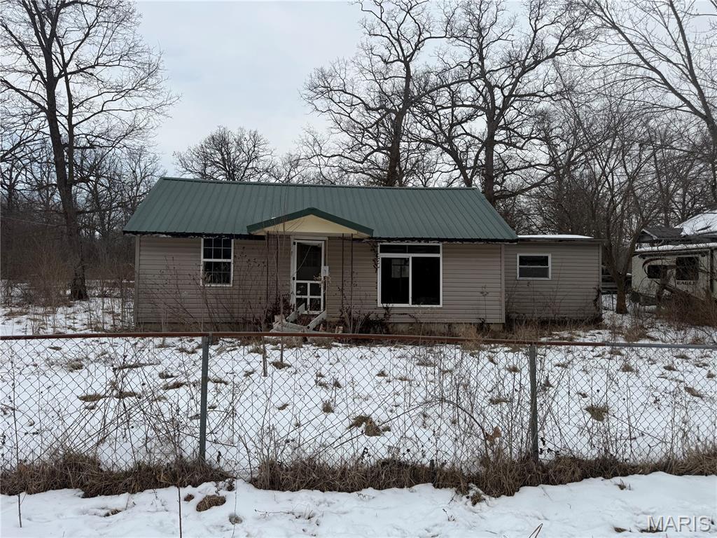 This single-story ranch offers three bedrooms and one bathroom and sits on a corner lot in Iron Mountain Lake. The property features a chain-link fence and plenty of potential for the right buyer. A true fixer-upper, this home will need some TLC, making it a great investment opportunity for those looking to renovate, add value, or create a rental property. With its solid layout and location, this property is a chance to bring your vision to life. seller financing available.