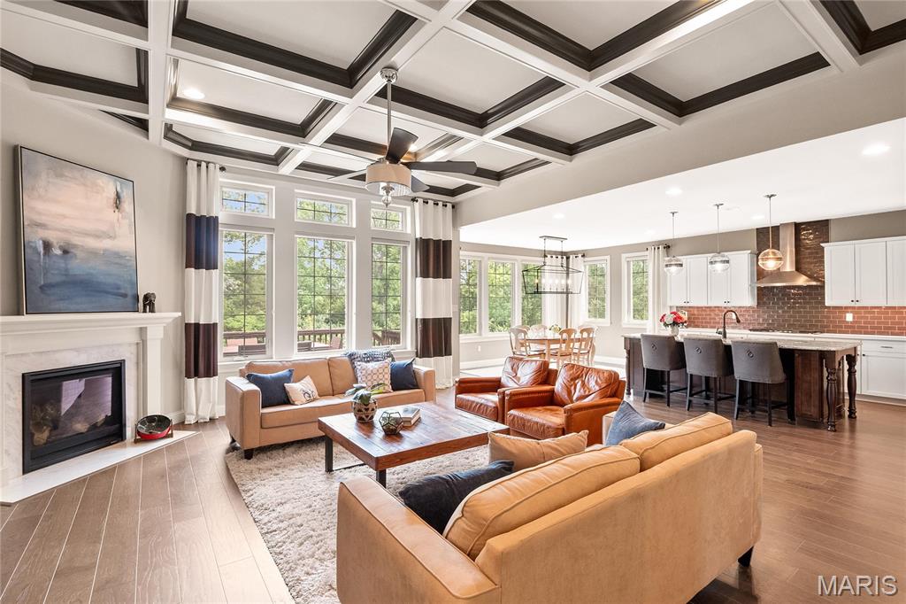 Stunning ranch in premier Creve Coeur location situated in one of the most coveted neighborhoods, this exquisite former display home seamlessly blends sophisticated style with luxurious upgrades throughout. A striking turret-style entry with a wood front door sets the tone, welcoming you into a ML boasting 9’ ceilings & doorways, wide-plank hardwood flooring (excluding bedrooms & baths) & elegant glass French doors opening to a home office.  A formal dining room with box-molded chair rail connects seamlessly to a butler’s pantry & an impressive kitchen outfitted with white raised-panel cabinetry, an expansive center island, granite countertops (on island), quartz countertops, glass subway tile backsplash, gas range, double ovens, & a sun-filled eat-in area with walk-out access to the deck.  Backs to trees. The adjacent family room features double box-molded ceilings and a stunning gas fireplace w/a custom hearth. The main floor also offers a spacious primary suite, a second bedroom ensuite, convenient laundry, & a separate mudroom. The professionally finished walk-out LL is designed for relaxation, recreation & entertainment featuring a third bedroom, full bath, expansive rec room, full bar with dishwasher, ice maker, beverage fridge, granite counters, bar seating, stacked stone columns, & an additional sleeping area. This home offers unparalleled comfort, function, and style in a truly exceptional location. ML 2664 sq ft, LL 2018 sq ft.
