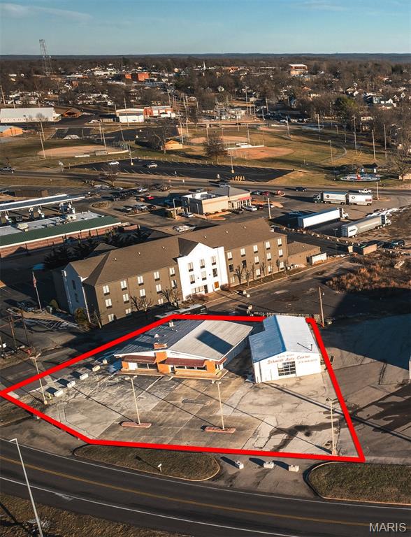 Positioned in a prime high-traffic corridor along I-44 in Sullivan, this versatile commercial property offers outstanding visibility and exposure for a wide range of business ventures. The property features two buildings totaling over 4,000 square feet, each equipped with heating and cooling for year-round comfort and usability. The existing improvements include two glass garage doors, making the space ideal for automotive use, showroom space, or businesses that benefit from natural light and accessibility. This property is perfectly suited for a car dealership, mechanic shop, construction company, professional services, or office space. In addition to its current functionality, the property presents a valuable redevelopment opportunity. With its strategic location and strong traffic counts, the site would be an excellent candidate for a gas station, restaurant, fast food establishment, coffee shop, or other retail venture. Whether you're looking to utilize the existing structures or reimagine the site for new development, this property offers endless potential in one of Sullivan’s most visible and accessible locations.