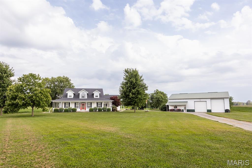 Experience country living at its finest with this Custom Build Home and Pole Barn on 5.09 acres.  A welcoming wraparound porch sets the tone, offering morning coffee spots and evening sunsets. The bright, open interior features a well-appointed kitchen with spacious living and dining areas for gatherings, and comfortable bedrooms with plenty of natural light.  Endless possibilities with 2 Main Level Bonus Rooms, one on each side of the home, perfect for office space, extra entertaining area or hobbies.   The Upper Level is also plumbed for a 3rd bathroom, Geothermal Furnace, Gas Fireplace, and Roof 2024.  Pole Barn is 40X60, 220 hookup with an enclosed Lean-to, and separate well pump. Thoughtful touches and quality finishes create a warm, move-in ready atmosphere. Outside, the expansive yard, mature landscaping, Pecan Trees, and potential for gardens, or outdoor enjoyment and homestead living. Conveniently located yet private, this property marries rural tranquility with everyday comfort.
