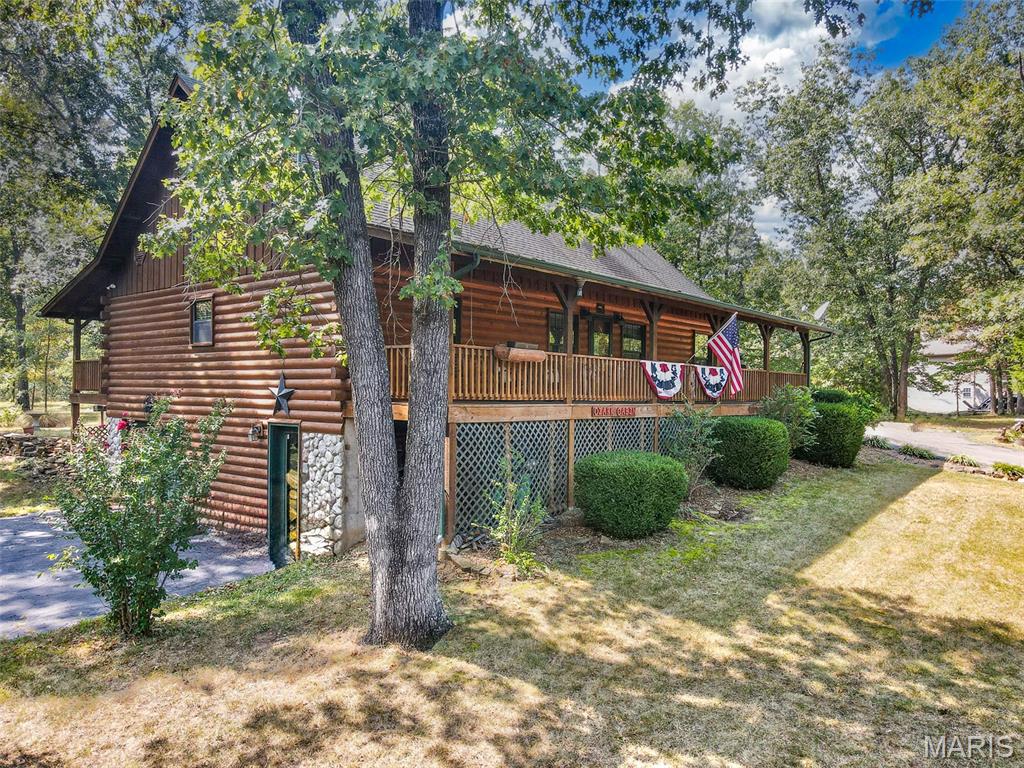 Stunning, authentic log home perfectly situated in a park-like setting on a generous 1.47-acre lot m/l.
Step inside to experience the undeniable warmth of soaring natural wood ceilings and a majestic floor-to-ceiling stone fireplace. The open-concept living space transitions seamlessly into a spacious kitchen, making it perfect for both cozy family nights and grand entertaining.
Main level features two bedrooms, two baths, laundry room, kitchen, dining area, and large living room with vaulted ceilings. Additional, third bedroom and rec room (possible fourth bedroom) are located upstairs.
Outside, the vast property offers an expansive canvas for your outdoor dreams. Relax on one of two covered porches, host weekend gatherings, or simply enjoy the mature trees and peaceful wildlife passing by. The lower level features a highly desirable two car tuck-under garage, and plentiful storage, and a wood furnace. Need more space? The property also includes a two-car carport with an attached workshop, perfect for DIY projects or extra storage. Don’t miss your chance to own a piece of rustic paradise—schedule your private tour today!