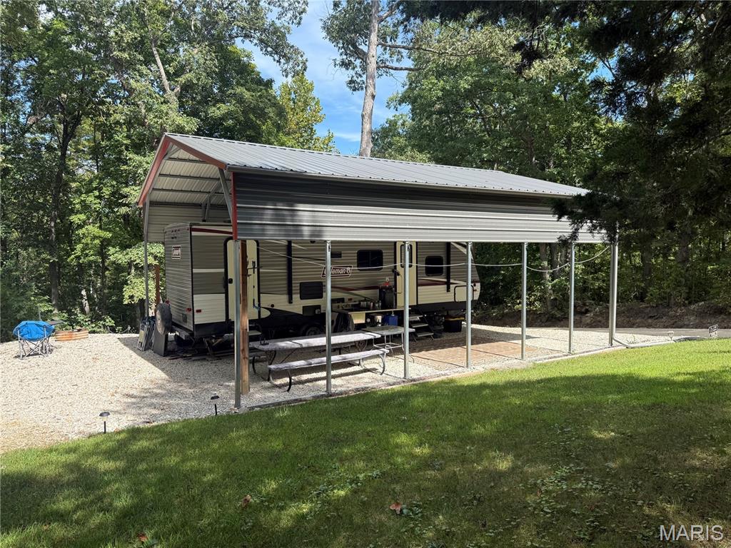Pinnacle lake lots with close access to the main gate and lake access! Open, cleared lot just down from the beach and common grounds of Pinnacle Lake. This lot offers a gravel driveway and gravel pad for a camper/RV with a covered 25x30 canopy and flag pole. Canopy does have guttering and a screen for additional shade, etc. 119 Skyline Dr, is an additional lot that is include that comes with a gravel area for boat storage or another great spot for a camper/RV site. Both lots have 20 and 30 amp hookups. Currently no septic and water. 2019 Coleman camper is available for additional cost, if desired. Call for more info!