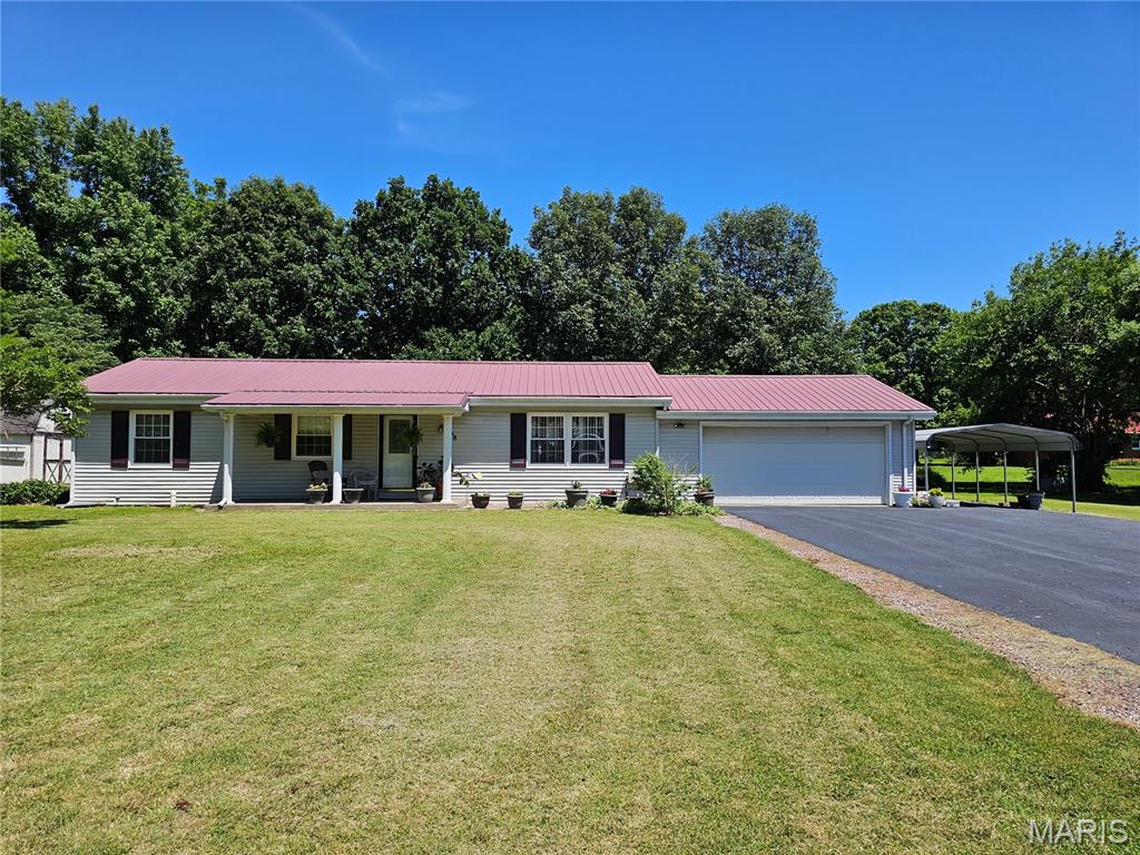 Welcome home to comfort, charm and peaceful living! Situated on a spacious half-acre lot in a quiet neighborhood on a dead-end road with no through traffic. This well-maintained, smoke free home offers the perfect blend of privacy and convenience. Enjoy the beautifully updated interior featuring freshly painted bedroom and kitchen, stunning hickory hardwood flooring in the living room. Enjoy the bright sun room surrounded by windows that fills the space with natural light. Major updates provide peace of mind, including replacement windows(2021),gas furnace (2021)hot water heater(2021), and a durable metal roof (2010).  The kitchen comes complete with stainless steel appliances, making it move-in ready.The 2 car garage is insulated and heated along with a carport for extra coverage for your vehicles. The asphalt drive  has recently been  sealed in 2026.
The home is conveniently located near a park, this property offers a wonderful setting for relaxation and outdoor enjoyment.  Don't miss the opportunity to make this inviting home your own!