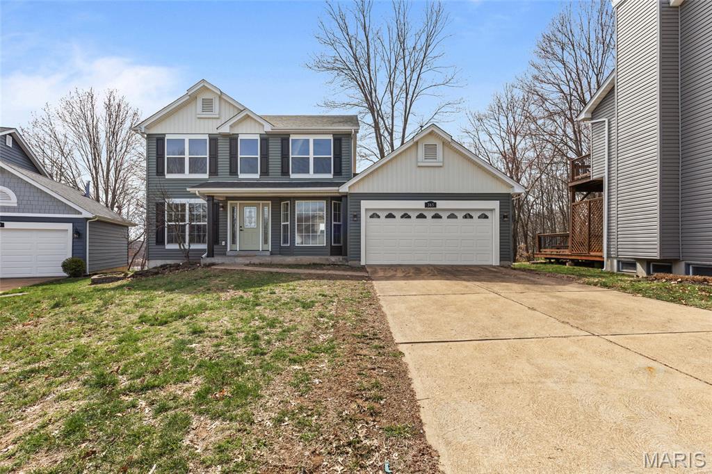 Experience Elevated Living in Parkway South school district. Be impressed by this meticulously 
reimagined 2-story retreat with over 2600 Sq ft of living space. From the moment you arrive, the all-new siding, stately porch columns, and designer front door signal that no detail has been overlooked. As you enter the home, notice the 
hardwood flooring that guides you through a formal living room, dining area and cozy family room with a wood burning fireplace. The kitchen features gleaming stone countertops and 42" soft-close maple cabinetry, along with stainless steel appliances and a gas stove for those who enjoy the art of cooking. Stairs leading to the upper level have a window allowing natural light to shine in and leads you to a spacious hallway lending itself to 4 bedrooms and a modern style hall bath. Retreat to your vaulted primary sanctuary, with a stunning view of nature with privacy where a spa-like bath awaits with a sleek standalone tub and private shower. Need space to entertain: then you will find the finished lower level is your new headquarters for game day, complete with a custom bar and built-in shelving. Whether you're hosting a summer BBQ on the massive new deck or enjoying a quiet morning overlooking your spectacular, private wooded view, this home isn't just a place to live, it's your private escape. Just minutes from 141 and 44.