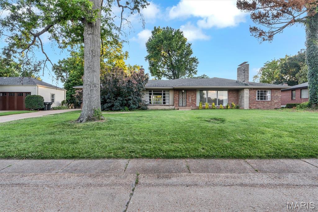 Hard to find Mid Century Modern Ranch that is priced to move.  Put your special touches on this wonderful property.  Set on a gorgeous lot.  Hardwood flooring underneath the bedroom carpeting.  3 Fireplaces.  Main floor laundry.  Rear entry garage.  Partially finished basement.  Lots of windows to let the natural light in.  Seller offering this property "As Is".  This one is a Gem and wont last long!