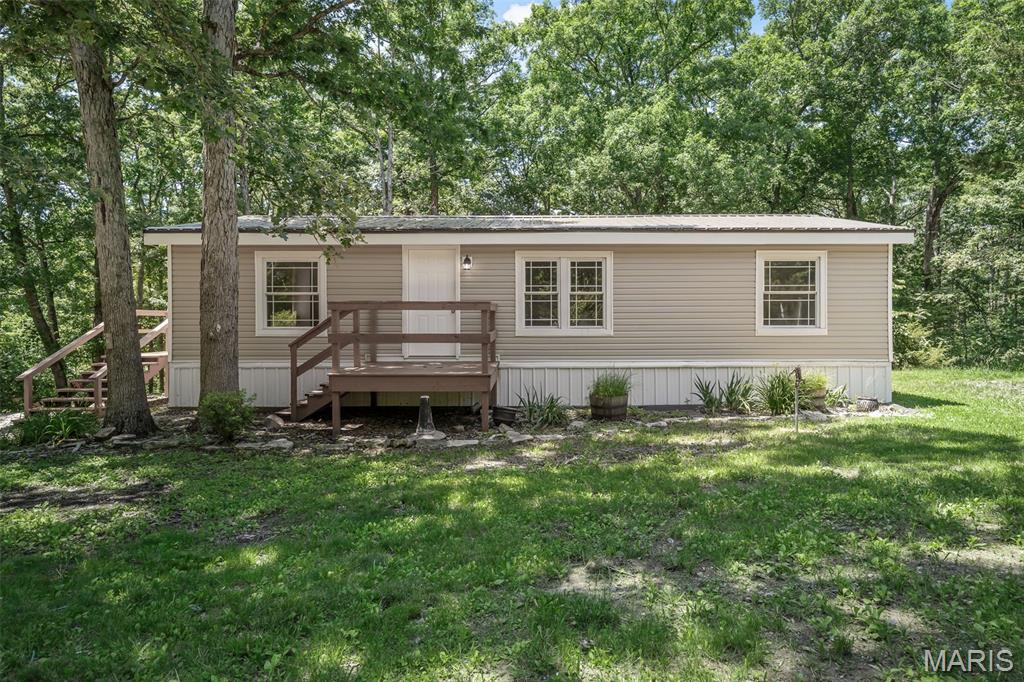 Tucked away on a 2.94-acre lot, down a quiet private lane shared by just 3 other homes, this fully updated ranch offers space, privacy, and a great natural setting. The property is mostly wooded with gently rolling ground, giving it a peaceful, country feel while still being just a short drive to Warrenton. Inside, you'll find 3 bedrooms and 2 full baths, all completely updated from top to bottom. The vaulted ceilings give the main living space an open, airy feel, and the luxury vinyl plank flooring runs throughout the entire home. The kitchen and both bathrooms have been nicely redone with modern finishes, and everything has a fresh, clean look. Big-ticket items are already taken care of, including a new roof, new HVAC system, and fresh paint, so you can move right in without needing to do anything. Good size mud room/laundry room as you come in the side deck. Outside, you've got two good-sized decks-perfect for relaxing, entertaining, or firing up the grill and enjoying the quiet surroundings. Detached garage with overhang for additional storage. If you've been looking for a move-in ready home with acreage and privacy, this one is definitely worth a look.