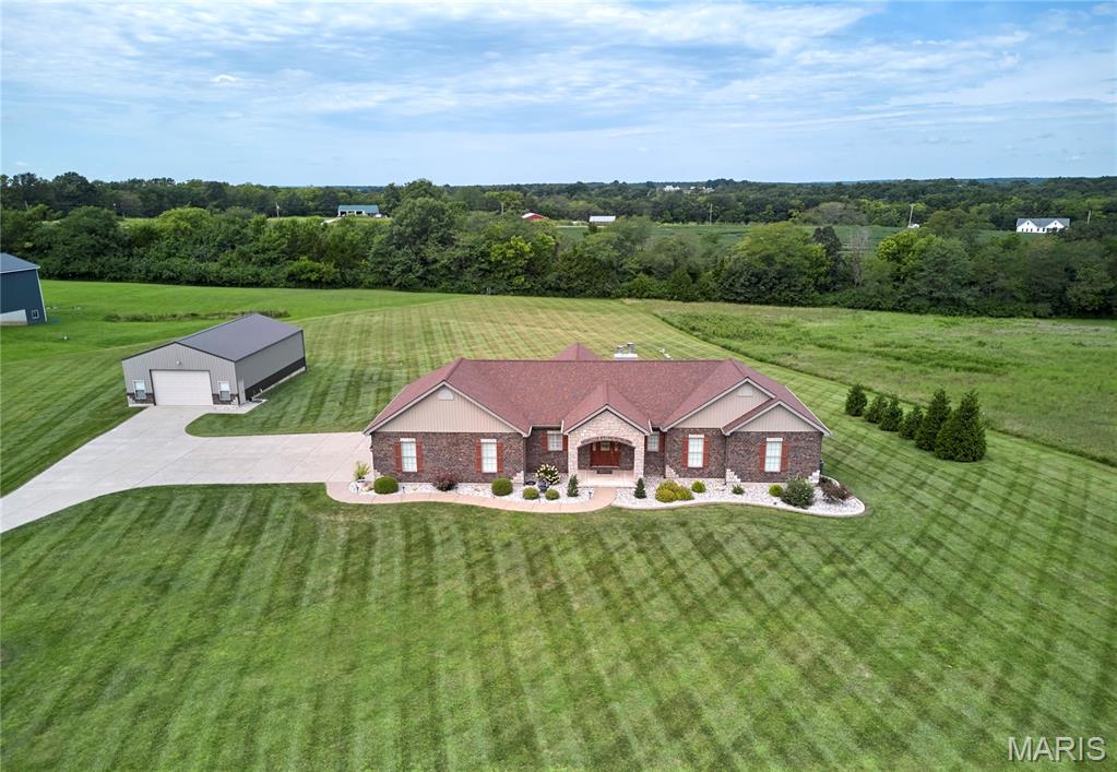 Concrete driveway leads you to this Amazing 1882 sq ft Custom built home on 3 wonderful acres with 3000 sq ft of finished living area! The home boasts quality inside and out with with 3 car attached garage plus a  30X50 garage/shed with concrete floor and 220 electric-Home has incredible appeal with Open floor plan,coffered ceilings, 2 fireplaces (one in great room the other in basement) Gourmet kitchen with  granite countertops, custom cabinets and walks out to 15X20 covered deck-coffered ceilings in master bdrm with luxury bath featuring large walk in shower and dual sinks-large main floor laundry-3+ bdrms (there is a room that could be finished for 4)-3 total baths-walkout basement has family room, rec area, custom bar with lights and so much more plus walks out to huge patio-heat pump system saves on utility costs-Troy schools-southern Lincoln County-county water-there is talk about possible blacktopping of subdivision roads,  no decisions made yet