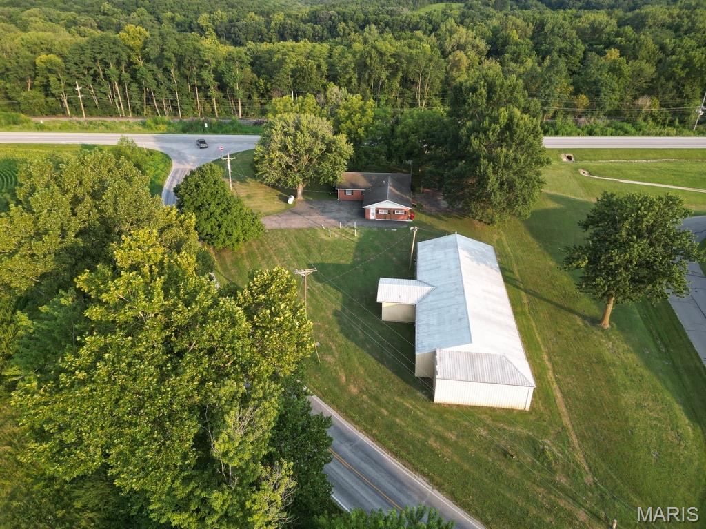Beautiful Pike County Missouri! Endless possibilities on one acre just outside the Louisiana city limits! Conveniently located between Louisiana and Bowling Green, this unique property combines main-level living with hobby, commercial and investment potential.
The brick home offers spacious main-level living, while the 3,874 sq. ft. metal building opens the door to countless uses. One half features a large garage/workshop with three overhead doors, ideal for a business, warehouse, equipment storage, vehicles, RVs, boats, or hobby space. The other half, formerly used as a church, includes finished office space, gathering areas, and three bathrooms. Note: A portion of Interior finishes removed due to remediation of mold which formed while closed up during a period of inactivity - now complete the space to fit your needs.
Perfect for a home-based business, contractor, warehouse, workshop, art studio, event venue, storage, or even modify for additional residential space. With excellent visibility, a versatile layout, and room to grow, this one-of-a-kind property is ready for your vision.