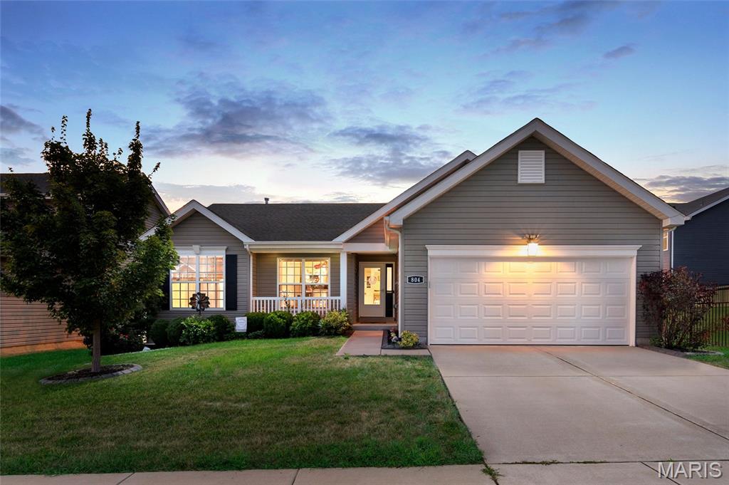 Welcome home to this beautifully maintained 3-bedroom, 2-bath ranch in the desirable Wynstone community! Built just 7 years ago, this move-in ready home offers an open, inviting floor plan with vaulted ceilings and durable laminate flooring throughout the main living areas. The kitchen is sure to impress with bright white cabinetry, stainless steel appliances, a spacious pantries (yes, there's 2!), breakfast bar, and a gorgeous new designer backsplash that adds the perfect modern touch. A main-floor laundry room is off the 2 car garage with additional broom closet and cabinetry. The dining area opens to a spacious deck overlooking the fully fenced backyard, creating the perfect space for relaxing, entertaining, or enjoying summer evenings. The private primary suite features a large walk-in closet and an ensuite bath complete with double vanities, a luxurious soaking tub, and separate shower. Two additional bedrooms offer comfortable living with cozy carpet underfoot. The full unfinished basement provides endless possibilities for future living space, storage, or recreation, with a ¾ bath already roughed in for added convenience. Located in a welcoming neighborhood with walking trails and easy access to Lake Saint Louis amenities, this home combines modern style, functionality, and room to grow. Don't miss your chance to make 804 Hazy Hills Drive your next home!
