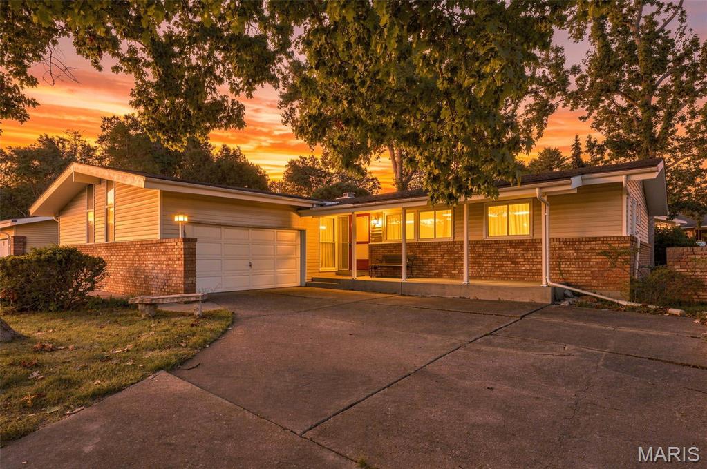 Bring your vision to this spacious 4-bedroom, 2.5-bath ranch in the Creve Coeur area and Parkway C-2 School District. Mid-century flair shines throughout the home with vaulted ceilings and a striking floor-to-ceiling brick fireplace. The primary bedroom includes an ensuite bath with a generous footprint and excellent renovation potential. Original hardwood flooring is beneath much of the carpeting. A lower level offers room for additional living space or storage, while the oversized garage provides space for vehicles, tools, or a workshop. The home offers a great flat backyard with apple access through two large patio doors. Enjoy optional access to the neighborhood pool and a convenient location minutes from the Page Extension, I-270, and Highway 141. Nearby highlights include Creve Coeur Lake Memorial Park and Westport Plaza, both about a 10-minute drive away. The property is being sold as-is.
