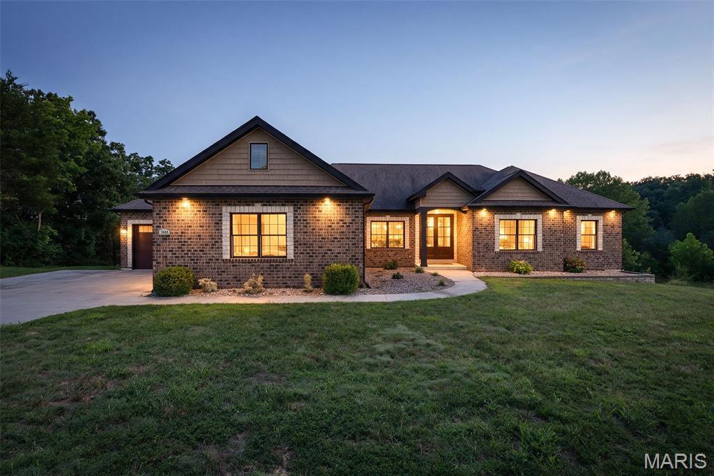 Nestled on over an acre in the scenic hills of Imperial, this custom-built 2,174 sq. ft. ranch home offers breathtaking views, exceptional craftsmanship, and thoughtfully designed living spaces built with 2x6 walls.Enter through rich mahogany doors to a spacious, open-concept floor plan featuring gorgeous laminate flooring and 9-foot ceilings. The living room and breakfast room are filled with natural light from an abundance of windows and showcase beautiful, vaulted ceilings. In the living room, you will find amazing views, a cozy brick ventless gas fireplace, built-in bookshelves, and a ceiling fan. The breakfast room features elegant French doors that access the 16x16 covered composite deck. Complete with a ceiling fan and TV, this outdoor space overlooks incredible views and wraps around to a convenient garage entry. The deck's finished, vaulted ceiling features LED recessed lighting, complemented by wired posts with integrated LED lights. The gourmet kitchen features 42-inch custom cabinetry, under-cabinet lighting, granite countertops, a large center island, a pantry, double built-in oven, and a 5-burner gas cooktop. A separate dining room provides the perfect setting for holidays and special occasions. Even the laundry room is impressive, offering a sink, abundant cabinetry, and a huge storage closet. The primary suite features a tray ceiling, crown molding, built-in lighting, and an oversized walk-in closet. The primary bath includes a double vanity, a large closet, and a huge double-head walk-in shower. Two additional generously sized bedrooms and a full bath complete the main level. The 9-foot-pour walkout basement has two sets of double doors, a bathroom rough-in, sump pit, and an open layout ready for your finishing touches. Outside, enjoy a mostly level, private yard with plenty of space to relax and entertain. The oversized stamped-concrete driveway provides plenty of parking and leads to an impressive 4-car garage (two double-car garages) featuring 8-foot insulated doors and a fully finished interior. This truly custom home has so many special touches and is a must-see!  **New roof to be installed prior to closing**