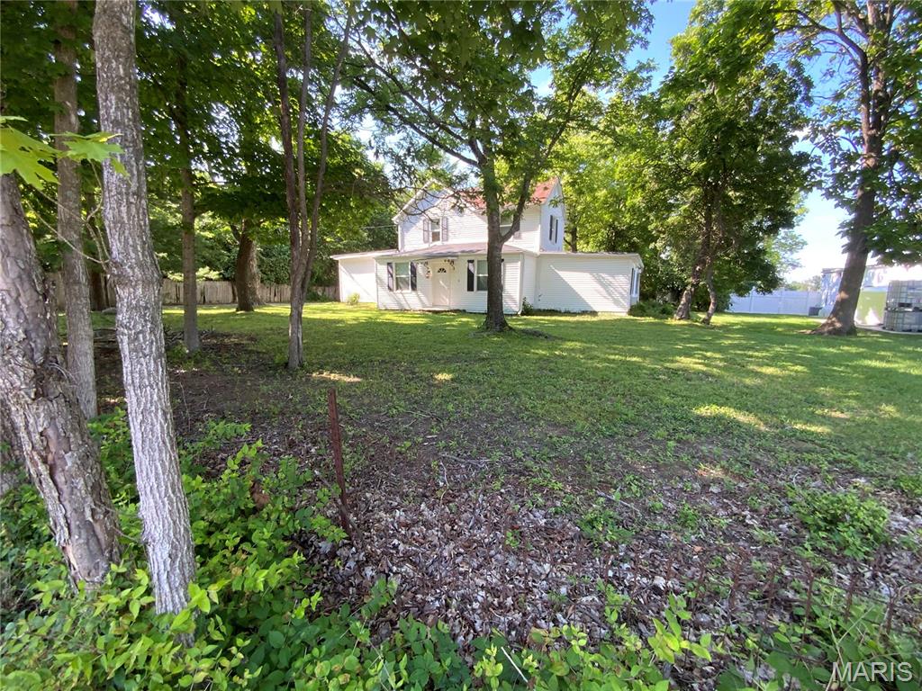 Rare opportunity in the heart of Wildwood's Town Center Historic District! Situated on a beautiful 0.546-acre lot (23,784 sq. ft.) along Old Manchester Road, this charming circa 1880, 1.5-story home offers endless possibilities for homeowners, investors, and business owners alike.

Home is on a Septic system. 

With over 3,249 square feet of living space, this historic property features 9 rooms, 5 bedrooms, 2 full baths, and 1 half bath, including a main-floor primary bedroom, main-floor laundry, and spacious living areas throughout. The inviting living room showcases a wood burning  fireplace, while the updated kitchen offers granite countertops, stainless undermount sink, GE Profile refrigerator, Whirlpool smooth-top electric range, Whirlpool dishwasher, ceramic tile flooring, and abundant cabinet space. The spacious laundry room includes a washer and dryer and features ceramic tile flooring.

The second floor provides additional bedrooms, a full bath, generous closet space, and ample storage. Mature trees, a stone patio, and a detached garage enhance the property's appeal and create a picturesque setting.

Numerous improvements completed prior to 2014 include 200-amp electrical service, furnace and air conditioning, vinyl siding and replacement windows..

Currently zoned residential, the property may offer the potential for rezoning to certain commercial uses, subject to municipal approval. Its highly visible location along Old Manchester Road could make it an excellent candidate for a professional office such as a law office, insurance agency, real estate office, consulting practice, or other approved commercial use. Buyers should independently verify zoning and permitted uses with the City of Wildwood.

Adding to the property's appeal, it is located along Historic Route 66 during the highway's 100th anniversary celebration. The City of Wildwood will be hosting its Route 66 Centennial Celebration on July 17 and 18, offering residents and visitors the opportunity to enjoy this historic landmark and the community events commemorating this milestone.


The expansive lot also presents the opportunity to renovate, expand, or potentially build a custom home in one of Wildwood's most sought-after locations. Conveniently located just minutes from shopping, dining, parks, and easy access to both I-44 and Highway 64/40.

Located in the Rockwood School District, this unique property combines historic charm, modern updates, exceptional visibility, and outstanding potential. Property is being sold AS IS.

Hurry—don't miss this rare opportunity to own a piece of Wildwood history with unlimited possibilities!