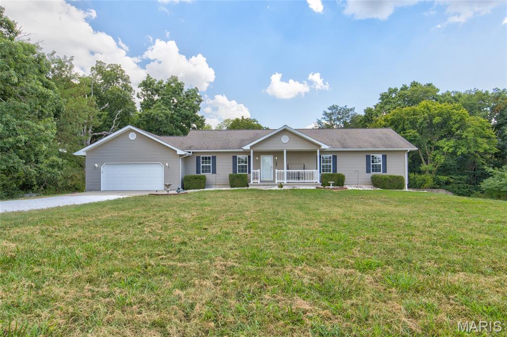Welcome to your private retreat! This 3-bedroom, 2-bath home sits on 10 acres of land, offering space, privacy, and endless possibilities. Watch the sunrise sitting on your front porch or enjoy the outdoors from the patio overlooking the expansive backyard surrounded by trees. All the electric and utilities are underground, so your view isn't obscured with wires or cables. Inside, the home offers a functional layout with the kitchen overlooking the backyard, propane gas fireplace in the living room, separate dining room, and main floor laundry room. The large primary bedroom has en-suite with dual vanity, jet tub, shower, and walk-in closet. The 9-foot poured concrete basement provides excellent additional space for storage, recreation, a workshop, or future finishing. The HVAC and water heater are high efficiency, and the septic was pumped this summer. Whether you're looking for room to roam, a peaceful place to call home, or acreage to bring your vision to life, this property offers a rare opportunity. Don't miss the chance to own 10 acres and create your own private getaway!
