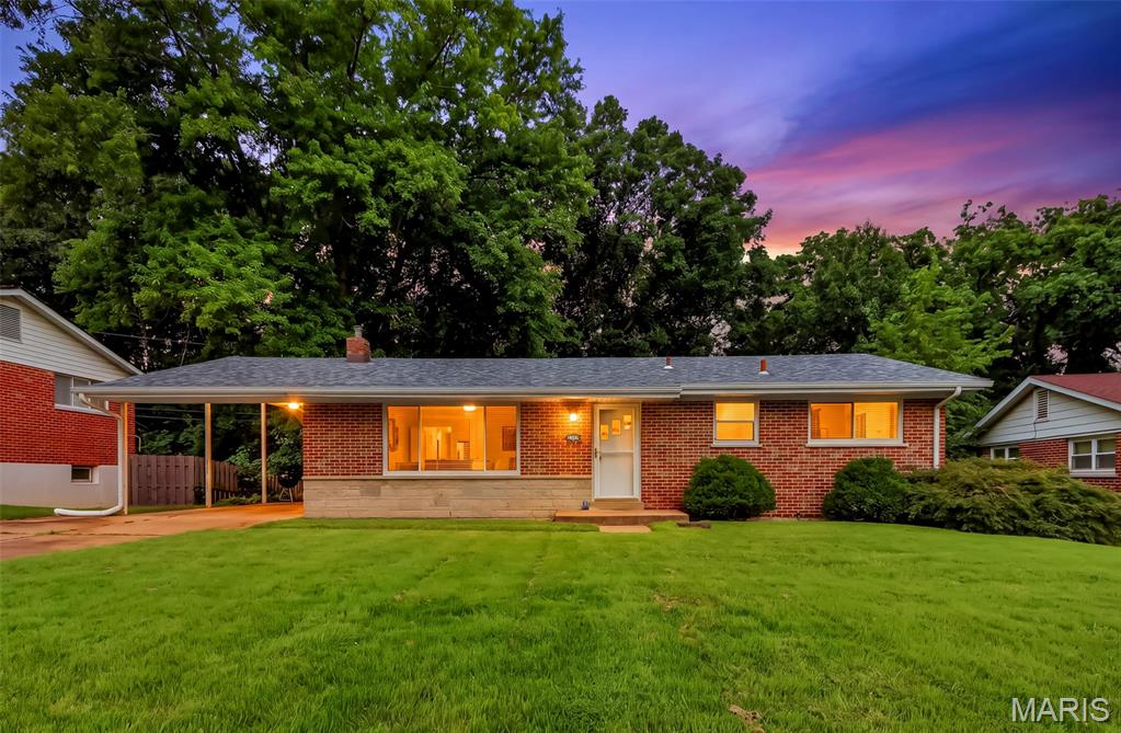 Welcome home to this beautifully maintained 3-bedroom brick ranch offering timeless charm and exceptional value. Hardwood floors flow throughout the main level, creating a warm and inviting atmosphere. The spacious eat-in kitchen features wood cabinetry, a breakfast bar, gas range with hood, dishwasher, stainless steel sink, and picturesque views of the fully fenced backyard. The oversized carport provides excellent covered parking and doubles as an ideal outdoor entertaining space, with potential to be enclosed for additional living area. The updated bathroom showcases a relaxing Jacuzzi tub, espresso vanity, and custom ceramic tile finishes. Outside, you'll appreciate the ample yard space for recreation, gardening, or play. The walk-out lower level offers endless possibilities with rough-in plumbing already in place for a future second bathroom. Additional features include extra off-street parking, a fully fenced yard, and major recent updates including a new roof (2025) and new Air Conditioner (2025). Nestled on a quiet residential drive in the desirable Warson Hills subdivision and located within the highly rated Pattonville School District, this home offers convenient access to major highways, shopping, dining, and recreational amenities. Municipal Inspection has already passed. Move-in ready with room to grow - don't miss this opportunity!