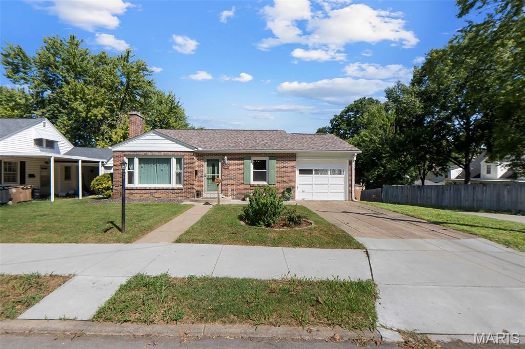 Don’t miss this charming 2-bedroom, 3-bathroom home in the heart of Cape Girardeau! Step into a sun-filled living room bathed in natural light and anchored by a cozy gas fireplace. The kitchen features butcher-block countertops and a convenient eat-in dining space. Ground floor laundry access adjacent to the master bedroom allows for exceptional convenience.

The finished walkout basement expands your living options with a versatile bonus room and full bathroom, making it ideal for a home office, guest suite, family room, or hobby space. Storage is abundant throughout, with extensive space in both the attic and basement.
Outdoors, relax or entertain on the back patio, complete with a built-in fire pit area framed by a shade and privacy wall. 

A 1-car garage and attached carport provide convenient parking and protection from the elements. Located centrally to everything in Cape Girardeau, this home blends character, natural light, functional layout, and exceptional storage.