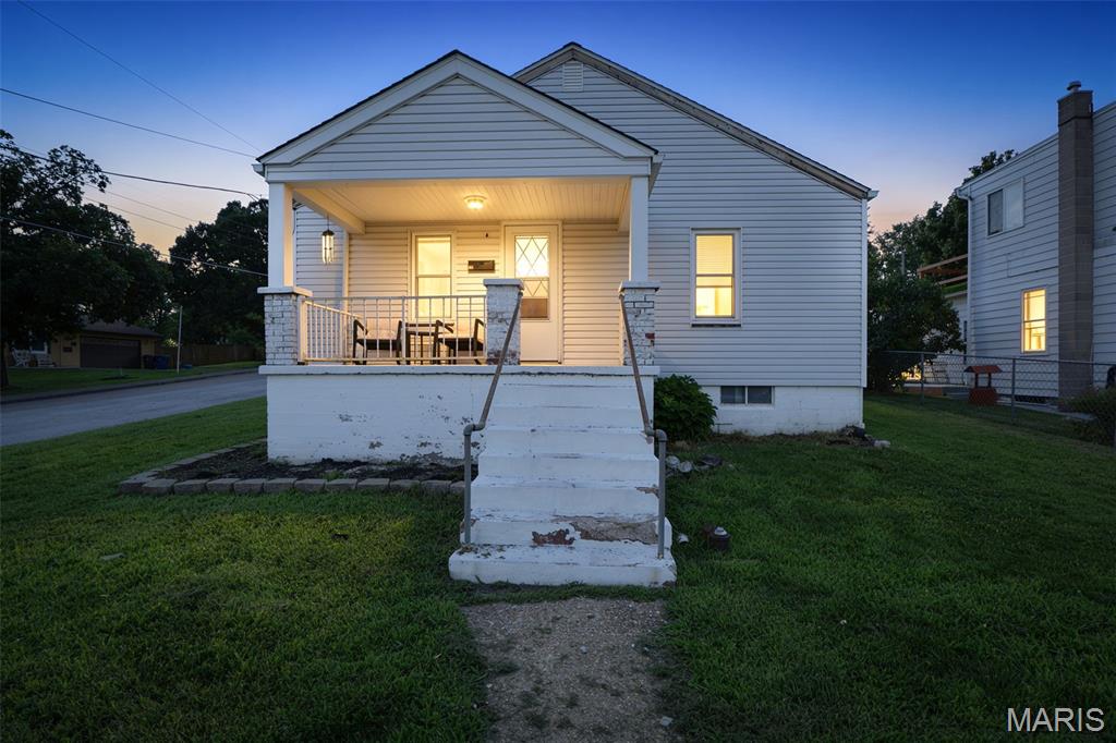 Welcome to this charming bungalow in the heart of De Soto!  Walk up to the inviting covered front porch, picture yourself relaxing, enjoying your morning coffee, and taking in the small-town charm around you.
Step inside to a spacious living room filled with natural light from the large windows, creating a warm and welcoming space to gather. The living area flows right into the eat-in kitchen featuring wood cabinetry, plenty of counter space, and everything you need to make this house feel like home.
The main level offers two comfortable bedrooms with good storage and a conveniently located full bathroom. Downstairs you will find the laundry area, additional storage space, and a walk-up exit to the backyard for added convenience.
The kitchen opens to the fenced backyard — and this outdoor space is the absolute best! Enjoy summer BBQs, evenings on the patio, gardening, pets, or simply having room to relax. The outbuilding offers additional storage, a great project space, or the potential to be used as a garage. With alley access, there are great options for additional parking.
You will love being close to historic downtown De Soto with local dining, shopping, parks, and community events just minutes away. Move-in ready, full of charm, and at a price that is hard to beat — come take a peek and see everything this home has to offer!