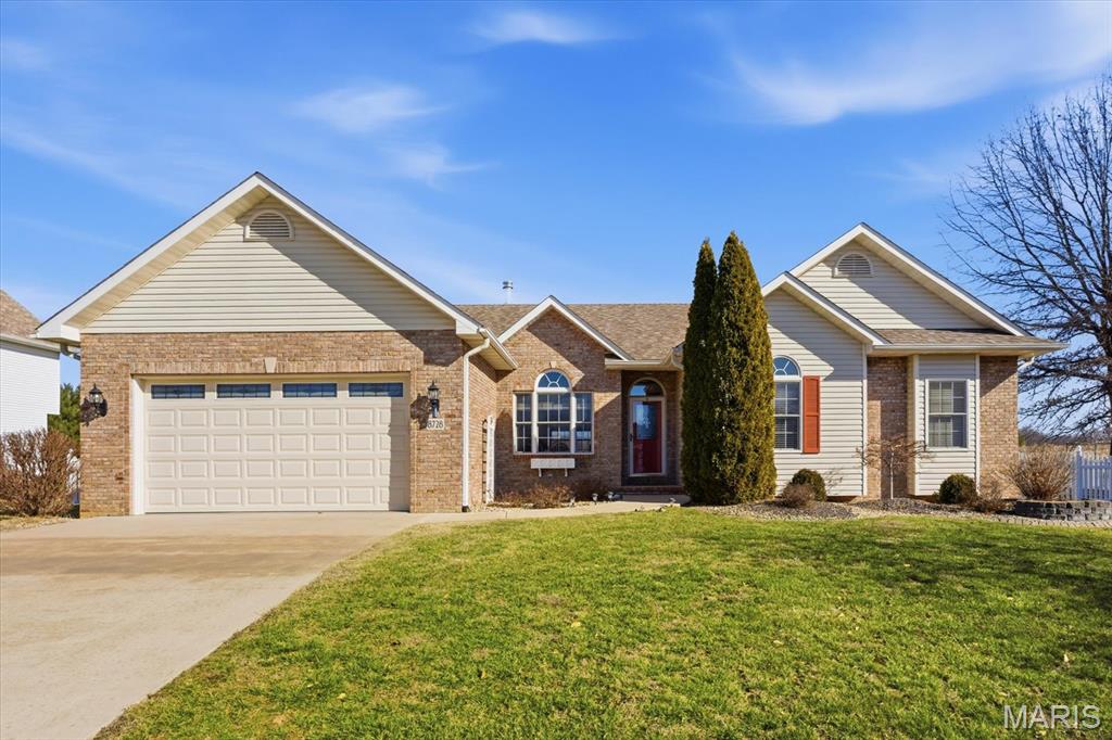 Beautifully updated ranch-style home offering refined comfort, thoughtful design, and exceptional outdoor space. The inviting brick and vinyl exterior, two-car garage, and welcoming front entry set the tone for a home that has been meticulously cared for. Inside, you’ll find soaring vaulted ceilings, rich engineered hardwood floors, and an open, airy layout filled with natural light. The spacious living room is anchored by a cozy see-through gas fireplace with an elegant surround and custom shelving; perfect for both everyday living and entertaining. The kitchen features stainless steel appliances, ample cabinetry, generous counter space, and a center island that flows seamlessly into the dining area, creating a warm and functional gathering space. The primary suite offers a peaceful retreat with engineered hardwood floors, a vaulted ceiling, and a private bath complete with dual vanities, a soaking tub, and a separate shower. Additional bedrooms provide flexibility for guests, a home office, or hobbies, while updated bathrooms showcase modern finishes and clean lines. Outdoor living truly shines with front-yard views of the community lake, a large deck overlooking a fully fenced backyard, and expansive open views, ideal for relaxing, entertaining, or enjoying quiet evenings. This home offers space to play, garden, or simply unwind, with picturesque scenery beyond the fence line. With its open floor plan, quality finishes, and blend of comfort and style, this home offers effortless main-level living in a desirable setting, with a neighborhood pool, Club House, a 17-acre lake, and a whole-house generator, all close to schools, parks, and everyday conveniences.  Before making an offer on any property, buyer should independently verify all MLS data derived from various sources and not warranted accurate.