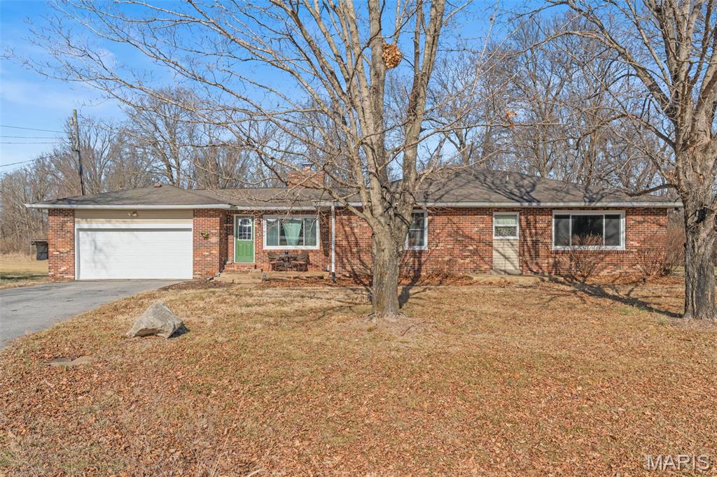 Enjoy peaceful country living on 5+ unrestricted acres backing to a beautiful creek and surrounded by abundant wildlife. This well-maintained brick ranch offers 3 bedrooms and 3 full bathrooms, featuring a cozy wood-burning fireplace, newer flooring and paint, updated HVAC, and numerous recent improvements throughout. Step outside to your private backyard retreat complete with an inground pool and a spacious 16x40 covered patio, perfect for entertaining or relaxing in total privacy. Need space for hobbies, equipment, or a workshop? The impressive 62x34 outbuilding includes concrete floors and a 16’x16’ overhead door, offering endless possibilities. This property blends privacy and functionality, all just waiting for you to call it home.