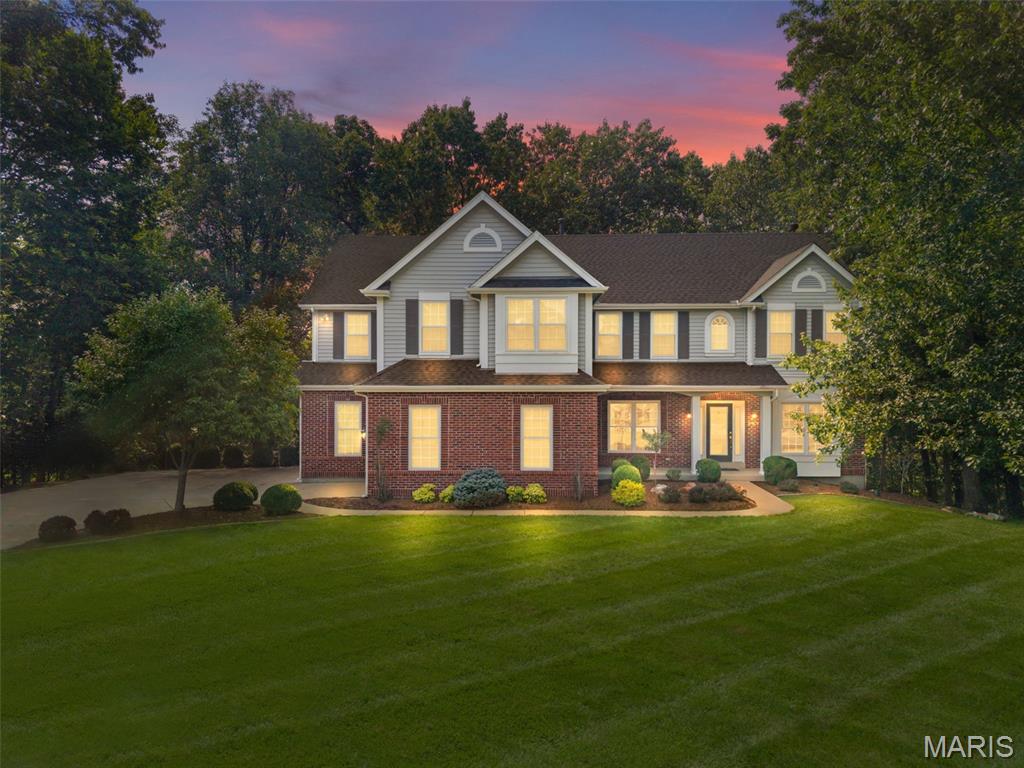 Welcome home to 991 Sheffield Forest Court in the highly sought-after Lakes at Sheffield Forest, an exclusive gated community in the heart of Wildwood. Perfectly situated on a private cul-de-sac lot, this beautiful two-story home offers 4 bedrooms, 3 full baths, 1 half bath, and an over-sized 3-car garage combining timeless elegance with exceptional living spaces.

Step through the impressive entry foyer and discover a thoughtfully designed main level featuring a formal living room and dining room, perfect for entertaining. The spacious family room is the heart of the home, showcasing rich hardwood floors, custom built-in bookcases, a cozy fireplace, and a charming bay window overlooking the tranquil backyard. The inviting eat-in kitchen is designed for both everyday living and entertaining, offering quartz countertops, custom wood cabinetry, a pantry, built-in desk area, and abundant workspace. Just beyond the kitchen, the light-filled sunroom with tile flooring provides the perfect place to enjoy your morning coffee while taking in peaceful wooded views. A convenient main-floor laundry room completes this level.

Upstairs, you'll find an expansive gathering room that offers endless possibilities as a media room, playroom, or second family room. The luxurious primary suite is a true retreat with generous space, a spa-inspired bathroom featuring a tiled walk-in shower, soaking tub, and separate vanities. Two additional bedrooms share a Jack-and-Jill bath, while the fourth bedroom enjoys its own private en-suite bath, providing comfort and privacy for family or guests.

The walk-out lower level offers exceptional potential with an egress window and rough-in plumbing for a future full bath. Whether you envision a recreation room, home theater, fitness area, additional bedroom, or home office, this space is ready for your personal touch. Outside, the private backyard backs to mature woods, creating a peaceful setting where deer, birds, and other wildlife are frequent visitors. Residents of Lakes at Sheffield Forest also enjoy several scenic neighborhood lakes, offering a picturesque setting for walks, fishing, and relaxing outdoors.
