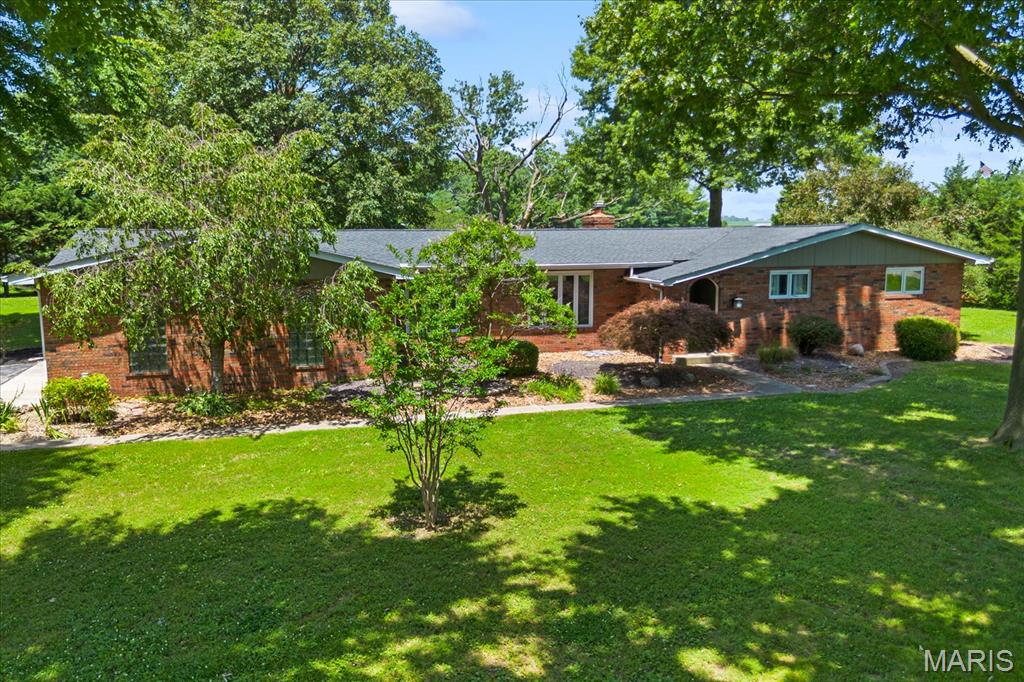 Looking for a little more space and no HOA? Situated on a 1.17 acre corner lot in the charming community of New Baden, this full-brick ranch offers the space and feel of country living, yet is just minutes from I-64, Scott Air Force Base, MidAmerica Airport, Boeing, and an easy commute to the St. Louis metro area. Inside, you'll find an inviting open floor plan with a sunken living room, spacious family room featuring a gas fireplace and office nook, plus an updated kitchen with quartz countertops, tile backsplash, stainless steel appliances, abundant cabinetry, and a large pantry. Hardwood floors run throughout much of the main living areas, while the guest bedrooms feature natural cork flooring that's both comfortable underfoot and a unique feature you don't see every day. Step outside to a large deck overlooking the spacious backyard with plenty of room to entertain, garden, gather around a fire pit, or simply enjoy the peace and quiet that comes with country living. Additional features include LeafFilter gutter guards, new attic insulation, new crawl space vapor barrier, garden shed, small fenced area for pets, oversized side-entry two-car garage, and all appliances included. Furnace and A/C (2019), electrical panel (2019), septic system serviced/pumped (May 2026). If you've been searching for a home with room to breathe and a convenient location, this one deserves a look!
