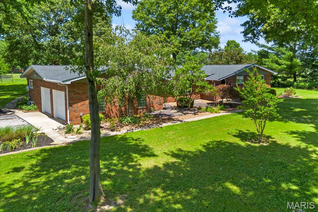 Looking for a little more space and no HOA? Situated on a 1.17 acre corner lot in the charming community of New Baden, this full-brick ranch offers the space and feel of country living, yet is just minutes from I-64, Scott Air Force Base, MidAmerica Airport, Boeing, and an easy commute to the St. Louis metro area. Inside, you'll find an inviting open floor plan with a sunken living room, spacious family room featuring a gas fireplace and office nook, plus an updated kitchen with quartz countertops, tile backsplash, stainless steel appliances, abundant cabinetry, and a large pantry. Hardwood floors run throughout much of the main living areas, while the guest bedrooms feature natural cork flooring that's both comfortable underfoot and a unique feature you don't see every day. Step outside to a large deck overlooking the spacious backyard with plenty of room to entertain, garden, gather around a fire pit, or simply enjoy the peace and quiet that comes with country living. Additional features include LeafFilter gutter guards, new attic insulation, new crawl space vapor barrier, garden shed, small fenced area for pets, oversized side-entry two-car garage, and all appliances included. Furnace and A/C (2019), electrical panel (2019), septic system serviced/pumped (May 2026). If you've been searching for a home with room to breathe and a convenient location, this one deserves a look!