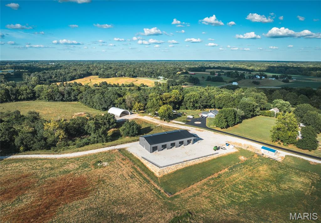 Welcome to this 157 acre +/- well designed cattle farm nearby the city limits of Alton, IL. This farm offers a combination of fenced pastures, alleyways, automatic waterers, feed bunks, hay fields, and outbuildings. The  main barn is nearly 8,000 sq ft and includes a large storage space, 5 overhead doors with openers, full bathroom, and a substantial awning. A hoop barn is nearby for sufficient hay or equipment storage. Interstate 255 and Homer Adams Parkway are within just a couple miles, allowing for easy commutes and access to amenities. There is a gravel roadway from the front all the way to the back for easy year round access.