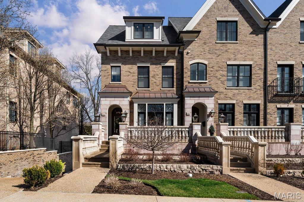 Experience an architectural masterpiece where refined design meets supreme convenience. This premier end-unit residence features 10-foot ceilings on the main level that flood the space with natural light. The main level showcases open-concept elegance, with timeless millwork and rich hardwood floors leading to a gourmet kitchen equipped with upgraded custom cabinetry, a Wolf six-burner gas range, and integrated Sub-Zero refrigeration. Enjoy the warmth of the hearth room fireplace before taking your private elevator to the primary suite, which offers a skyline view and a spa-inspired en-suite bath. Meticulously finished with high-end materials and heated floors, this private retreat provides the ultimate comfort in the morning and relaxation in the evening. Each additional bedroom has its own dedicated bathroom. The experience concludes on the third floor, where a recreation room with a built-in bar opens to an exclusive rooftop terrace. This terrace features an outdoor kitchen, a Wolf gas grill, Sub-Zero refrigeration, and a stone-surround gas fireplace for exceptional alfresco dining. The heated two-car garage offers unmatched convenience and is just steps from the restaurants and shops in downtown Clayton.