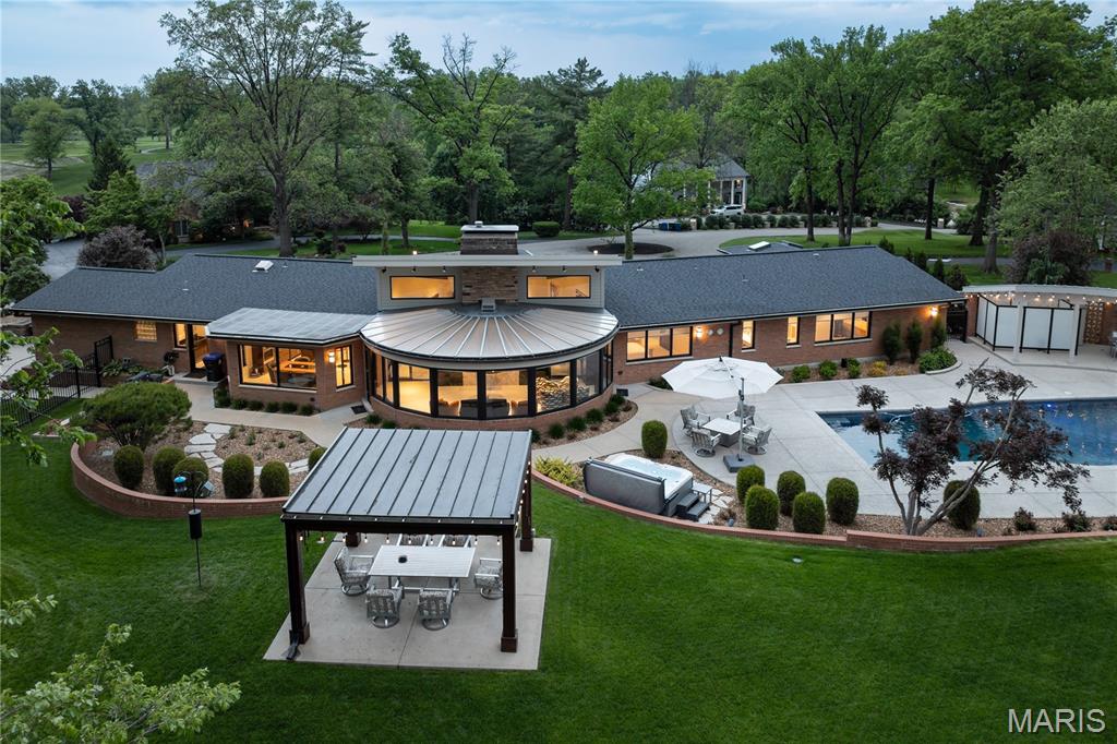 Don't miss out! Sharp price adjustment makes this stellar property an extraordinary cost value proposition for location, setting, size and condition. A must-buy Mid-Century Modern completely reimagined and rehabbed, inside and out effectively creating a 5 year old home, pool, and landscape. On the grounds of prestigious Westwood Country Club. 5BRs, 6BAs, and nearly 7,300SF of finished living area. The home pays homage to original architect Ralph Hohlt, while presenting a thoroughly modern masterpiece, with highest levels of finish and technology and a completely turn-key experience. No amenity is left undone. Hallmarks include vault ceilings, marble and stone flooring, solid mahogany doors, low voltage Smart House features including audio, video, lighting, heating, cooling, and security all controlled by touch screen or SmartPhone. Chefs kitchen showcases Zanzibar ebony and acrylic white high gloss cabinetry, SubZero, Wolf, Thermador, Bosch, and Fisher & Paykel appliances. Primary suite expansion created a luxe bath with room-size organized closet. A 2nd Primary Suite on Main Level is at the far end of Main Level, creating ultimate privacy and  separate quarters. A 5th suite on Main Level is ideal for in-laws/au-pair, with a private exterior entrance. Lower level includes media, recreation, exercise, and game rooms, full kitchen and bath, amd abundant storage. The pool is refinished; all systems rebuilt. Pool house with full bath and shower offer additional storage. Entirety of grounds, landscaping, retaining walls, patios and circle drive have been replaced. A pergola completes the property.