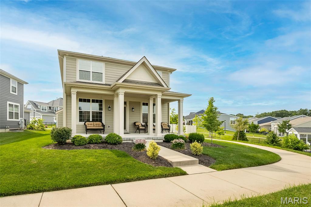 Craftsman charm meets modern living in this exceptional Payne-built home in one of Wildwood's most sought-after communities. Offering over 3,000 square feet of finished living space, this thoughtfully designed home features 4 bedrooms, 3.5 baths, a dedicated main-floor office, finished lower level with a full bath, second-floor laundry, and zoned HVAC. The heart of the home is the impressive kitchen showcasing a massive quartz island, white cabinetry, stainless steel appliances, and an open layout that flows seamlessly into the dining area and great room with a stunning stone gas fireplace. Outside, enjoy your morning coffee on the welcoming covered front porch or unwind beneath the covered gazebo, creating the perfect space for year-round outdoor entertaining. Located in the award-winning Rockwood School District, you'll enjoy a truly walkable lifestyle just moments from Wildwood Town Center, where restaurants, shopping, parks, scenic trails, the farmers market, and community events are all within easy reach!