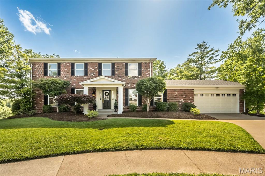Tucked away on a quiet cul-de-sac, this stunning brick two-story blends timeless curb appeal with beautifully updated living spaces and an exceptional layout designed for both everyday living and effortless entertaining in the heart of Oakville. Offering nearly 3,000 square feet on the main and upper levels plus approximately 1,000 square feet of finished living space in the lower level, this impressive home features 4 bedrooms, 2 full baths, and 2 half baths with room for everyone to spread out and enjoy.

The main level offers an ideal mix of formal and casual spaces, including a formal dining room for gatherings and special occasions, plus a spacious living room adjoining the inviting family room for great flow and functionality.

The true centerpiece of the home is the STUNNING 2023 kitchen renovation. Designed for both beauty and function, this spectacular space features gorgeous quartz countertops, sleek stainless steel appliances, extensive cabinetry, abundant prep and storage space, and an incredible 10-foot island that anchors the room and makes entertaining effortless. A separate butler’s pantry/laundry room adds even more storage and convenience.

Rich bamboo flooring throughout the first floor adds warmth and style, while beautifully updated bathrooms—including the primary bath renovated in 2020—offer a fresh, modern feel. The spacious primary suite is complemented by a truly incredible 13’ x 9’ walk-in closet complete with a darling chandelier—an absolute dream space with room for everything. Generously sized secondary bedrooms provide plenty of flexibility for family or guests.

The finished lower level adds additional living space and features a bar area perfect for entertaining, movie nights, or game days, plus a separate room ideal for a private home office, workout room, or flex space.

Step outside to the covered bar and entertainment area on the deck just off the family room—perfect for relaxing or hosting family and friends. Major updates including a newer roof (2023) and HVAC system (2018) complete this move-in-ready Oakville gem.