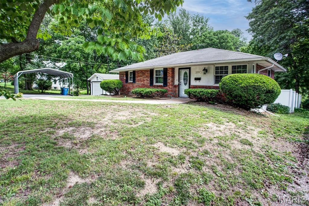 Welcome home to this charming all-brick 2-bedroom, 2-bathroom property situated on a spacious 1.13-acre lot. Inside, you'll find beautiful hardwood floors in the living room creating warmth and character. The kitchen features ceramic tile flooring, abundant counter space, and plenty of cabinetry for storage and meal preparation. It has a full basement offering a large family room that provides additional living and entertaining space. A convenient half bath was added in 2025, enhancing the home's functionality and value. Step outside to enjoy the concrete patio and walkout basement, perfect for relaxing or hosting family and friends. Approximately one-third of the yard is fenced, making it an ideal setup for dog lovers, pets, play, or gardening. Additional features include a 1-car detached garage, a 2-car carport, and numerous updates for added peace of mind. A new air conditioner was installed in July of 2025, and the furnace, appliances, washer, and dryer are all less than six years old and will remain with the home. The property also features a completely new sewer lateral installed just two years ago, extending all the way to the city main at the street. With its combination of indoor comfort, outdoor space, and valuable updates, this well-maintained property is one you won't want to miss!