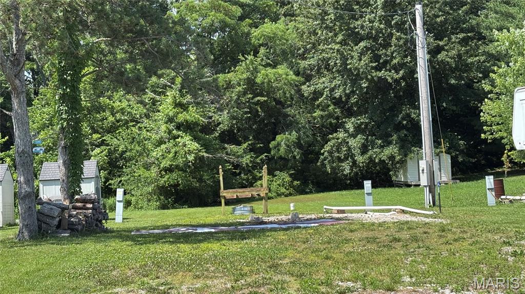 Design your own Retreat near Carlyle Lake.  Enjoy boating, fishing, hiking, bird watching, golf, camp fires, cook outs and great area dining.  Lot 141.  Electric, public water, and a holding tank are hooked up and ready, a head start for you to build your vacation dream home.  A garden shed is also included.