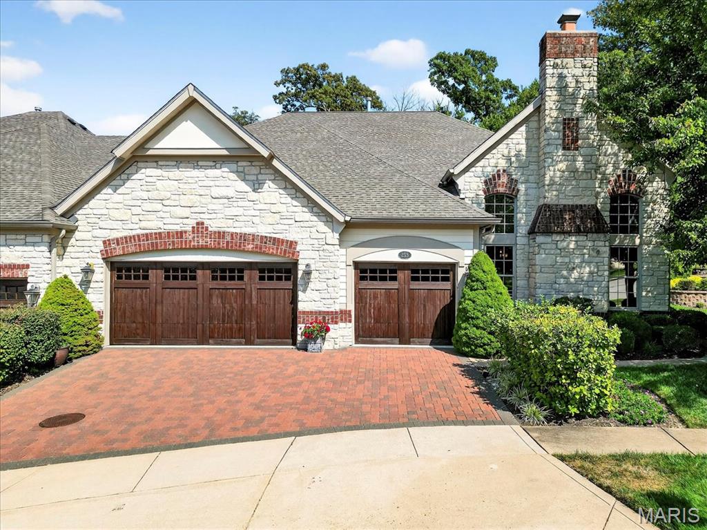 Experience luxury living in this stunning villa, perfectly situated on hole #6 at Meadowbrook Country Club. From the moment you step inside, you’ll notice the rich wood floors, dramatic ceilings, and custom millwork that elevate every space. The gourmet kitchen boasts custom cabinetry, granite countertops, stainless steel appliances and a tray ceiling, while three fireplaces throughout the home create inviting places to relax. The main floor primary suite offers a tranquil retreat with a four-window
bay, two custom closets, and a spa-like bath adorned with Botticino marble with custom cabinetry. The walk-out basement is perfect for entertaining with a stone fireplace featuring built-ins, custom wet bar, game area and full bath and bedroom. Outside, enjoy a huge covered paver patio with extended sitting area and firepit. This move-in ready villa is the renowned Canterbury Display Home, showcasing designer-selected finishes and timeless details throughout. Private lot backs to trees with amazing views of Meadowbrook Country Club with easy access to the club, golf, tennis, pickleball and pool. Wonderful resort living in a peaceful setting and maintenance free lifestyle.