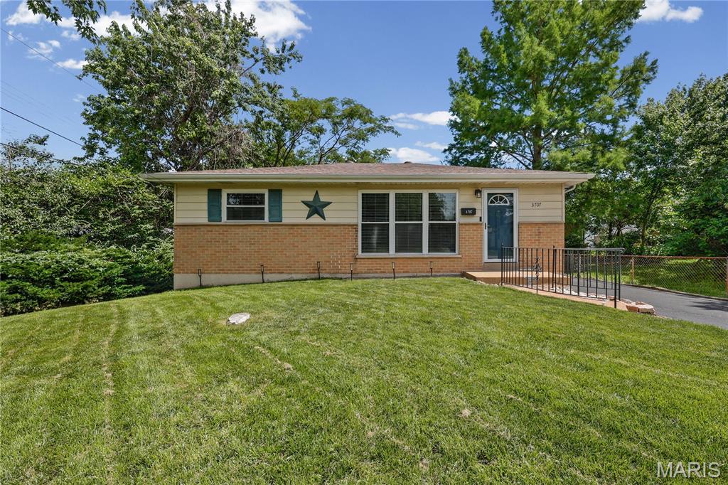 This charming bungalow is full of character, natural light, and additional living space you don't often find at this price point! The main level features a spacious living room, dining area, and kitchen with a comfortable flow that's perfect for everyday living. Hardwood flooring extends throughout the living room, hallway, and both main-floor bedrooms, adding timeless charm and easy maintenance. With two bedrooms and a full bathroom on the main level this home ensures easy living. Need extra space? The finished lower level offers the perfect bonus area! Whether you're looking for a family room, game room, home office, workout space, or entertainment area, you'll love the flexibility this lower level provides. Complete with a wet bar and a second full bathroom with a shower, this space is ready for movie nights, gatherings with friends, or simply relaxing after a long day. Outside, you'll find a fully fenced backyard with plenty of room for pets, play, gardening, or enjoying a quiet evening outdoors. The detached one-car garage and additional off-street parking provide convenience and extra storage space. Whether you're purchasing your first home, looking to downsize, or simply searching for a move-in-ready property with additional living space, this home checks all the boxes. Conveniently located and priced to sell, this is an opportunity you won't want to miss. Schedule your private showing today before it's gone!