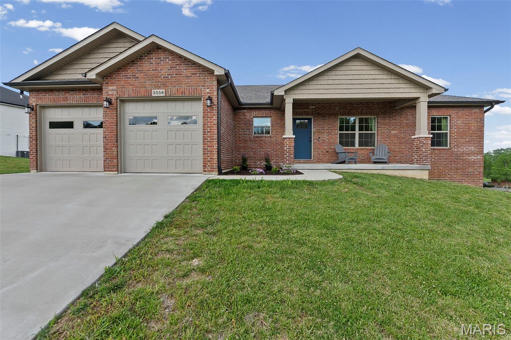 If “move-in ready with room to grow” is on your list, 3558 Mill View Crossing delivers. Built in 2022, this 1500+ square foot home features a practical layout and all the right upgrades. Step inside to an inviting living space with vaulted ceilings and that create an open, airy feel with tons of natural light warming the room from the large front windows and sliding glass back door. The open concept kitchen/dining area is ready to impress with stainless steel appliances including gas stove and a premium refrigerator complete with built in water pitcher and nugget ice maker, as well as a large island showcasing the matching granite countertops that carry seamlessly through the kitchen, bathrooms, and even the spacious main-level laundry room - complete with extra cabinetry. The spacious primary suite brings its own wow factor with a vaulted ceiling, a full bath featuring a dual vanity, tile shower, and a walk-in closet. Two additional bedrooms and a second full bath are comfortably sized and thoughtfully positioned on the opposite side of the home. Upgraded hardwood floors cover the entire main level and continue down the basement stairs. Downstairs, the unfinished walkout basement is already plumbed for an additional bathroom and features a drywalled ceiling - making it a blank canvas ready to easily add extra living space, fourth bedroom, rec room, or whatever fits your lifestyle. It also includes a John Deere room, giving you that extra storage space for lawn equipment, tools, or a workshop area. Step outside and take your pick of the covered front porch, covered patio, or partially covered deck to relax and unwind or entertain guests. Tucked away in a quiet subdivision, this practical and polished home is ready for you to make it yours!
