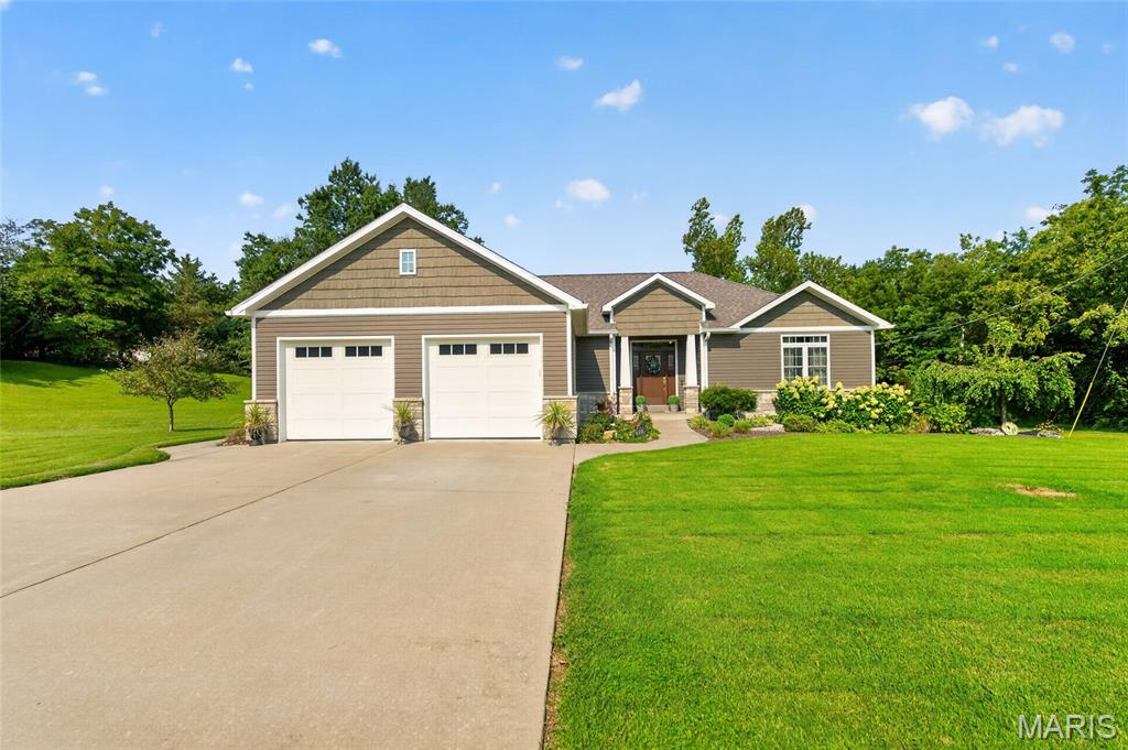 Welcome to this stunning, one-of-a-kind home situated on 3.28 beautiful acres within the city limits of Perryville! From the moment you walk through the front door, you’ll be welcomed by warmth, character, and an abundance of natural light. Gorgeous hardwood floors flow throughout the main level and lead you into the impressive chef-inspired kitchen, featuring a massive center island, granite countertops, a gas range with hood, new stainless steel appliances, and beautiful cabinetry. Just steps away is an oversized walk-in pantry thoughtfully designed with plenty of space for groceries, small appliances, and all your cooking essentials. The open-concept living room offers the perfect combination of comfort and style, highlighted by a beautiful stone gas fireplace and new ceiling fan. Nearby, the combined laundry and bathroom area provides excellent storage along with a convenient built-in ironing board. Down the hall, walk into the spacious primary suite, complete with a large bedroom, generous closet, double vanity, tiled floors, and a gorgeous custom walk-in tiled shower. On the opposite side of the home, you’ll find two additional bedrooms with hardwood floors and another spacious full bathroom. The lower level offers endless possibilities, with plenty of space to create a fourth bedroom, additional bathroom, family room, home gym, game room, or whatever best fits your lifestyle. Step from the main level onto the deck or walk out from the lower level to the patio and enjoy your own private oasis. Beautiful landscaping, mature trees, natural rock, and an abundance of open space provide the perfect spot for entertaining, relaxing, or simply enjoying the peaceful surroundings. Don’t miss your opportunity to make this exceptional 3.28-acre property your own!