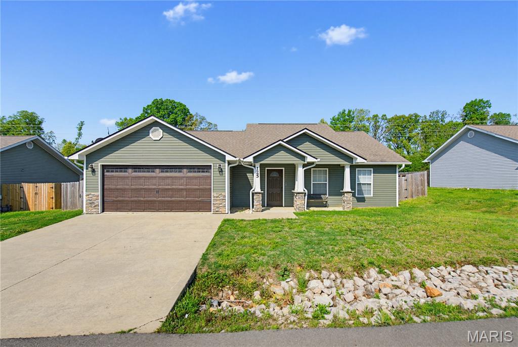 Welcome home to this move-in-ready Craftsman-style ranch home, offering exceptional curb appeal and a thoughtfully designed open-concept layout. From the moment you step inside, you’re greeted by low-maintenance concrete floors that flow seamlessly throughout the home, abundant natural light, and a soaring vaulted ceiling that creates a bright, airy atmosphere.
The spacious living area is anchored by a striking stone gas fireplace that's perfect for relaxing evenings or entertaining guests. The open kitchen features stainless steel appliances and provides direct access to the covered back patio, making indoor-outdoor living effortless.
The private primary suite is a true retreat, complete with a vaulted ceiling, a spa-like ensuite bath featuring dual sinks, a tiled shower, and a large walk-in closet. Two additional bedrooms are generously sized and share a conveniently located hall bathroom.
Step outside to a generously sized backyard, fully enclosed with a privacy fence, offering plenty of space for entertaining, play, and pets.
With its thoughtful layout, quality finishes, and inviting outdoor space, this home truly checks all the boxes for comfort, style, and functionality.