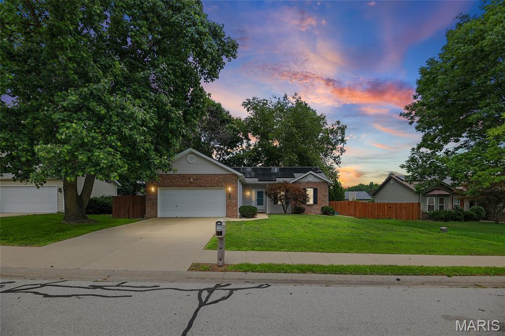 Welcome home to this beautifully maintained one-story home offering the perfect blend of comfort, style, and modern updates! Attractive brick and vinyl siding, a two-car attached garage, and outstanding curb appeal make a great first impression. Step inside to discover new luxury vinyl plank flooring throughout and soaring vaulted ceilings that enhance the spacious living room that features a gas fireplace and remodeled kitchen. Completed in 2020, the kitchen renovation created an open-concept design featuring beautiful cabinetry, quartz countertops, updated faucet and lighting, garbage disposal, reverse osmosis system, and a stainless steel appliance package—perfect for everyday living and entertaining. The generous-sized primary suite is a relaxing retreat with a vaulted ceiling, ceiling fan, walk-in closet, and private ensuite bath complete with a soaking tub and separate shower. The desirable split-bedroom floor plan offers two additional spacious bedrooms and a full hall bath with a convenient linen closet. Major updates provide peace of mind, including a furnace replaced in 2019 with an extended warranty, a 50-gallon water heater installed in 2022, and toilets replaced in 2024. Solar panels are transferable to the new owner for added energy efficiency or can be removed at buyers request. You'll also appreciate the smart home features, including a Vivint security system that is connected to the smoke alarms, MyQ garage door opener, Ring doorbell, and Nest Wi-Fi thermostat. Relax year-round in the inviting sunroom overlooking the recently stained deck and fenced backyard with a storage shed. This lovingly cared-for, move-in ready home has everything you've been searching for—schedule your private showing today!