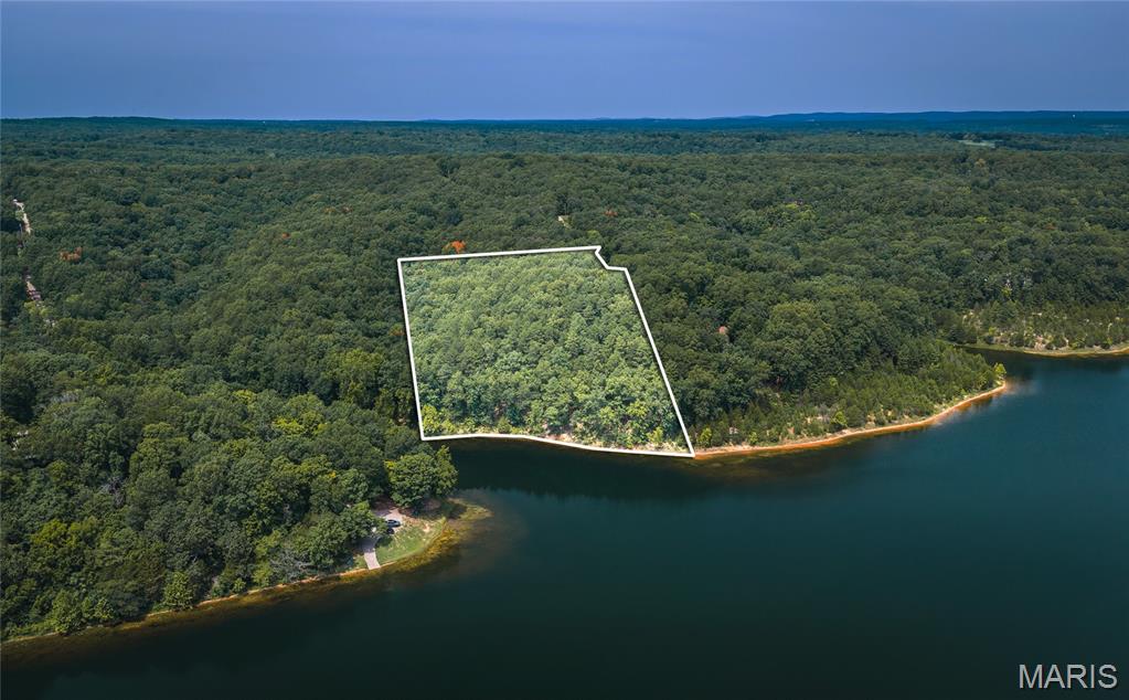 Discover a truly rare opportunity to own 5 acres in a private, gated lake community with approximately 200 feet of shoreline on an 80-acre lake. This exceptional property offers the perfect setting for a private retreat, full-time residence, or future lake home, with plenty of room to create your own vision.

Enjoy boating, water skiing, fishing, and relaxing along the shoreline of your own lakefront property. What truly sets this property apart is its deeded right to build a private dock—making it the only property on the lake with this unique privilege. Whether you envision a place to launch your boat, fish, or simply enjoy peaceful days on the water, this is a rare advantage that cannot easily be replicated.

The gated community offers an impressive collection of amenities, including two additional lakes, sandy beaches for swimming, a large community pool, and an onsite clubhouse. It’s a place where you can enjoy the privacy of your own acreage while still having access to a welcoming recreational community.

Conveniently located just down the road from Weingarten, MO where this is a Dollar General, restaurant and fuel station and only 12 miles from historic Ste. Genevieve, Missouri, this property combines seclusion and recreation with everyday convenience and easy access to one of Missouri’s most charming historic towns.

Five acres. Approximately 200 feet of shoreline. An 80-acre recreational lake. Deeded dock rights. A gated community with three lakes and exceptional amenities.

Opportunities like this are hard to find—especially one with the exclusive right to build a dock.