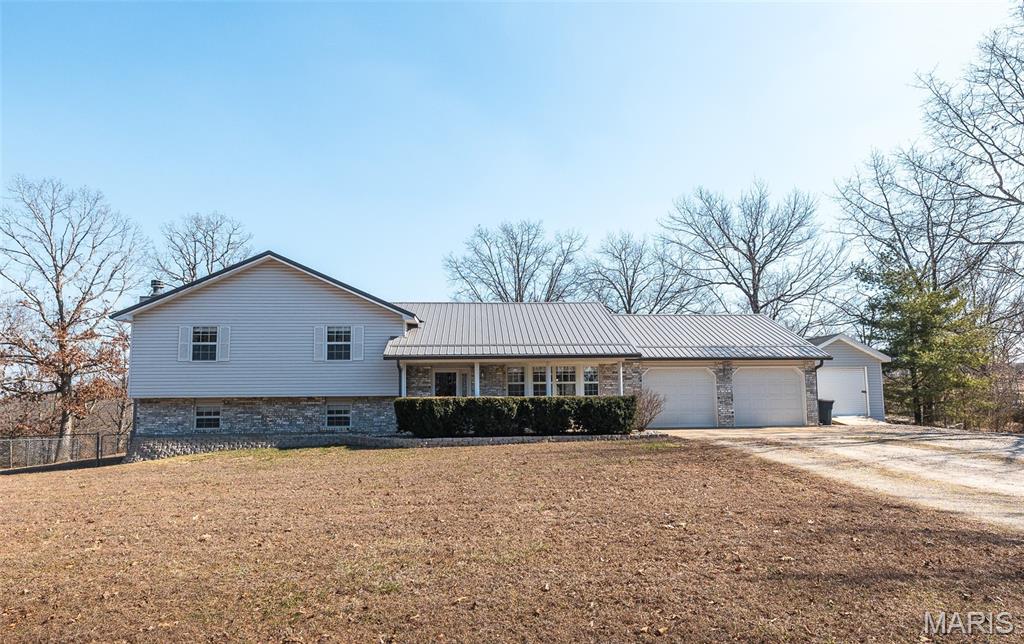 Spacious, updated, and tucked away on a quiet street, this 4-bedroom, 3-bath home sits on nearly an acre and offers room to spread out both inside and out. The main level welcomes you with a large living room, an inviting kitchen with ample space to cook and gather, and a dedicated dining area perfect for everyday meals or entertaining. Upstairs, you’ll find three generously sized bedrooms, including the primary suite featuring its own private deck — the perfect spot to enjoy your morning coffee or unwind in the evening. The lower level offers even more living space with a comfortable family room complete with a fireplace, creating a cozy retreat for movie nights or relaxing with family and friends. Step outside to enjoy the fenced backyard, ideal for pets or play, along with a storage shed and an impressive 1,500 sq ft detached garage/workshop — perfect for projects, storage, or running a home-based business. As an added bonus, the seller is offering a $5,000 flooring allowance with an acceptable offer, giving buyers the opportunity to customize and make the space their own. With large rooms throughout, thoughtful updates, generous outdoor space, and incredible workshop potential, this property offers the perfect blend of comfort, functionality, and flexibility.
