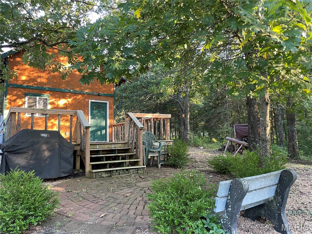 SUPER GREAT NEW PRICE! ** CHARMING & QUAINT CABIN RETREAT IN THE WOODS! NATURE & POTENTIAL COMBINED - Nestled in Fawn Lake Subdivision, just short walk from newly updated park area w/pavilion & playground! This cozy hideaway features a spacious deck perfect for morning coffee, courtyard area, grilling area & fire pit for making memories under the stars. 
Inside, the cabin offers a warm living space, rustic log-style loft bedroom for true cabin feel. Common bath house nearby in park area for added convenience or plenty of room to expand- add a bath & kitchenette to complete your perfect cabin retreat. Property also boasts extra parking -ideal for guests or outdoor gear along with newer metal storage shed! Some small finishes may be needed to make it your own woodland getaway & there's definitely opportunity to make it even more! Furnishings in cabin stay with property. All this comes with total of 5 lots totaling 1.2 acres.  ** Seller has been told possible to put in septic holding tank and pump periodically if wanting to add bathroom in cabin! As well as you can use the 250 gallon water vessels that stay and attach shallow well pump with kit to have hookup if want to add small kitchenette inside as well! "Approx" costs $5000 septic & $400 shallow well setup with water vessels ** 
* You must Check out the beach & picnic area on Lakeview Ct, the bath house, playground & pavilion party area on Chestnut and the boat access area on Wishwood! All these areas are updated and ready for families to use! *