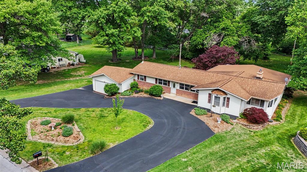 Welcome home to this expanded Ballwin ranch blending unique architectural flair with exceptional functionality. Backing directly to the Ballwin Golf Course on an impressive, park-like lot of over a half-acre, this 3-bedroom, 2-full-bath home is a rare find. The heart of the home features an updated kitchen boasting 42" cabinetry and solid surface countertops that flows seamlessly into an expansive family room anchored by a cozy, wood-burning fireplace. Thanks to the thoughtful family room addition, the home also features a dedicated formal dining space perfect for entertaining. The crown jewel of this property is the stunning, climate-controlled room addition. Complete with thermally heated flooring, soaring ceilings, and wrapped in crank-out casement windows, it bathes the space in natural light year-round. Crafters, hobbyists, or DIY enthusiasts will fall in love with the dedicated workroom, which offers a built-in sink with running water and an enormous worktable. The Lower Level features a versatile recreational space perfect for game nights, a designated sleeping area, a cedar closet, and the laundry hub. Garage & Storage: An oversized, fully insulated garage with a brand-new insulated door. Features rare dual-access points directly to the lower level through the garage and the main hallway. Behind the garage, double doors open to a storage space designed for lawn equipment, and additional storage. Unbeatable curb appeal featuring a double driveway, a convenient circle drive, and a dedicated outdoor RV power hookup.
A home with this many premium features on a premium lot won't last long. Schedule your private tour today—It’s Ballwin!