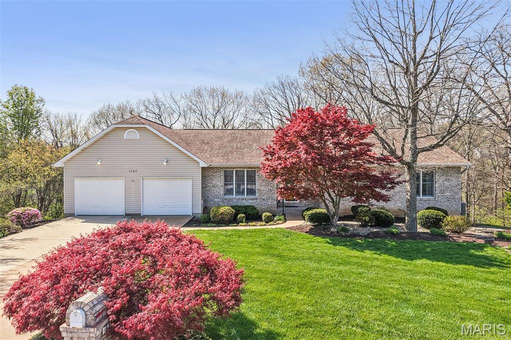 Tucked away at the end of a quiet cul-de-sac, this solidly built Ranch style home offers the rare advantage of a 1 acre lot without the burden of massive yard maintenance. The property features a natural wooded buffer where the yard extends halfway up the back hill, ensuring absolute privacy with no neighbors behind you and a serene view from every window. Inside, you’ll find a rock-solid, well-maintained canvas featuring a spacious floor plan accented by classic white six-panel doors and trim, along with the convenience of overhead lighting in every bedroom. The heart of the home is designed for both daily life and entertaining, featuring a functional kitchen with a dedicated pantry, a bright breakfast room for casual meals, and a separate formal dining room for special occasions. The home is designed for comfort across all seasons, boasting cozy wood-burning fireplaces in both the main-level family room and the expansive finished basement, which also includes an additional full bathroom for guests or growing families. While the interior retains its original oak cabinetry and vinyl flooring, the house is packed with high-end functional upgrades including a built-in central vacuum system, an inground sprinkler system to keep the front lawn lush, and a regularly maintained septic system for peace of mind. Storage and utility are front and center with an oversized two-car garage that features dedicated attic access via a permanent staircase, making seasonal storage a breeze. Outside, you can relax on the maintenance-free deck, which comes equipped with a built-in sunshade for those bright afternoons overlooking your private woods. This sturdy, "good-bones" home is exceptionally clean and move-in ready, offering a prime opportunity to build instant equity through cosmetic updates while staying just minutes from the vibrant Gravois Bluffs shopping district and its endless variety of restaurants and shops.