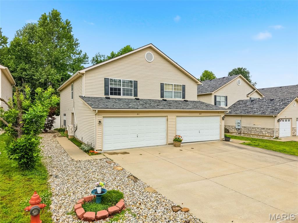 This beautifully updated 2-bedroom, 2.5-bath townhome offers low-maintenance, turnkey living in the desirable Woodside Creek neighborhood. Freshly painted throughout, this home features luxury vinyl plank flooring across the entire main level and newer carpet upstairs for a modern, move-in ready feel.

The bright and open main floor is designed for comfortable everyday living and easy entertaining, featuring a spacious living and dining area plus an updated kitchen with abundant cabinet storage, quartz countertops, subway tile backsplash, and stainless steel appliances. Main-floor laundry adds convenience, with washer and dryer included in the sale. Step outside through the sliding glass door to enjoy the private, fenced patio—perfect for relaxing or entertaining guests.

Upstairs, the spacious primary suite offers a walk-in closet and private full bath. A second bedroom also features a walk-in closet, while the versatile loft area provides the perfect flex space for a home office, media room, or potential third bedroom. An additional full hall bath completes the upper level.

Additional highlights include a 2-car garage, added mini-split system upstairs for enhanced comfort, and an ideal location just minutes from I-55, shopping, dining, and Festus schools. This one checks all the boxes—Welcome Home!