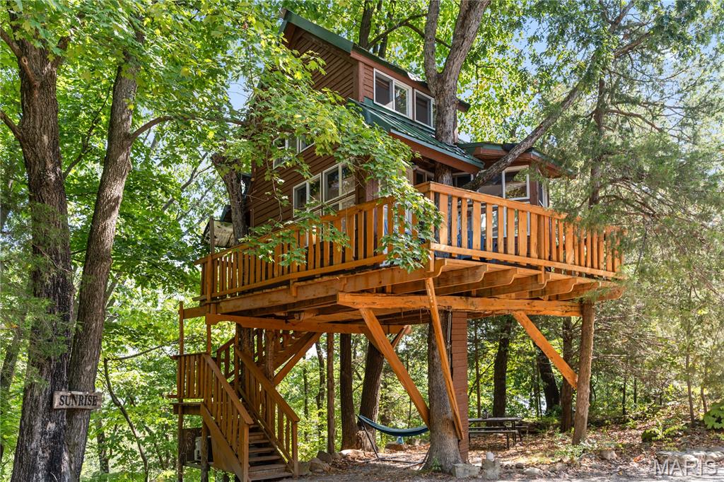 Investors looking for a proven hospitality property in Missouri wine country will not want to miss this one. For the past ten years, this business has delivered consistent five-star reviews, repeat
guests, and strong income, grossing over $200,000 annually. The offering includes three
custom-built treehouses, one cabin, a studio apartment, and an event venue with a full
commercial kitchen. Situated on 5.02 acres just minutes from downtown Hermann, the
property combines accessibility with privacy and has capacity for expansion with its oversized septic system. This is a rare chance to acquire an established short-term rental and event venue in one of Missouri’s most visited tourism market.